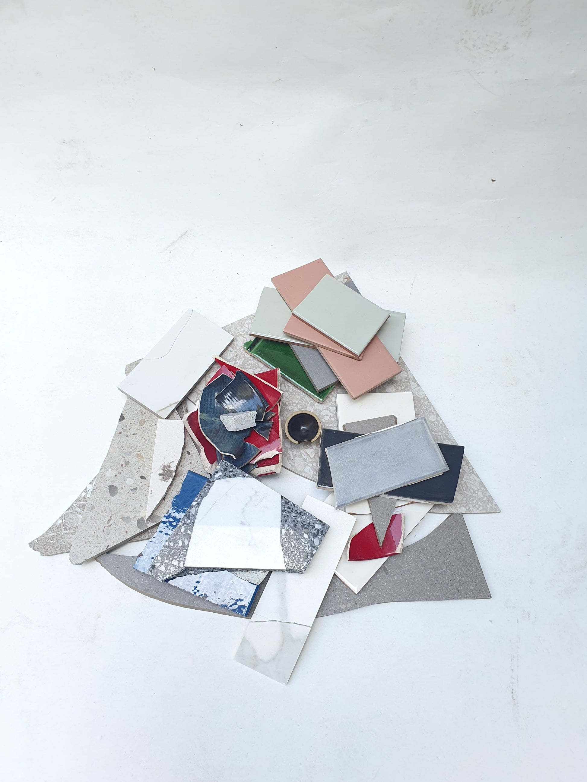 Collection of broken tiles in various colours and sizes 