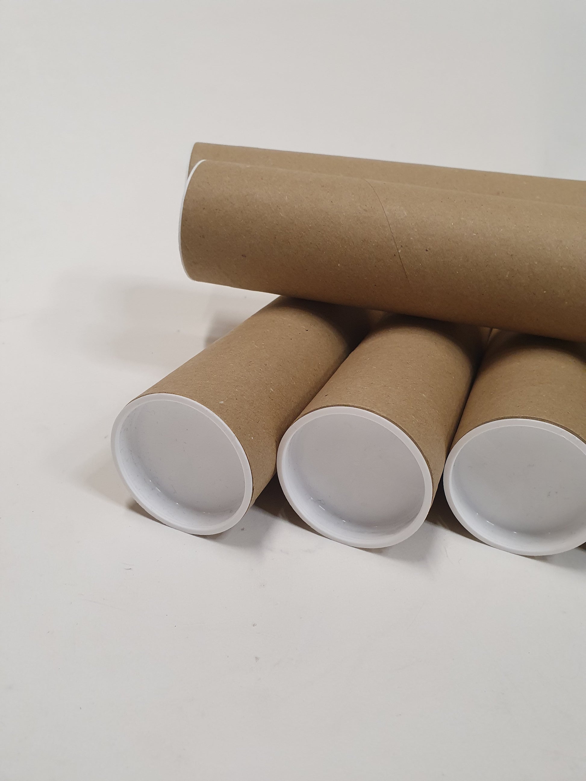 A close up front view of the brown cardboard packing tubes.