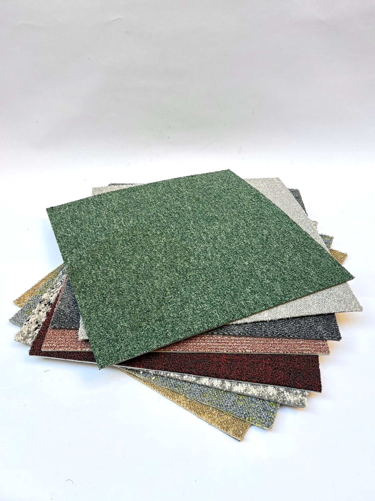 Collection of large square pieces of carpet samples in various colours 