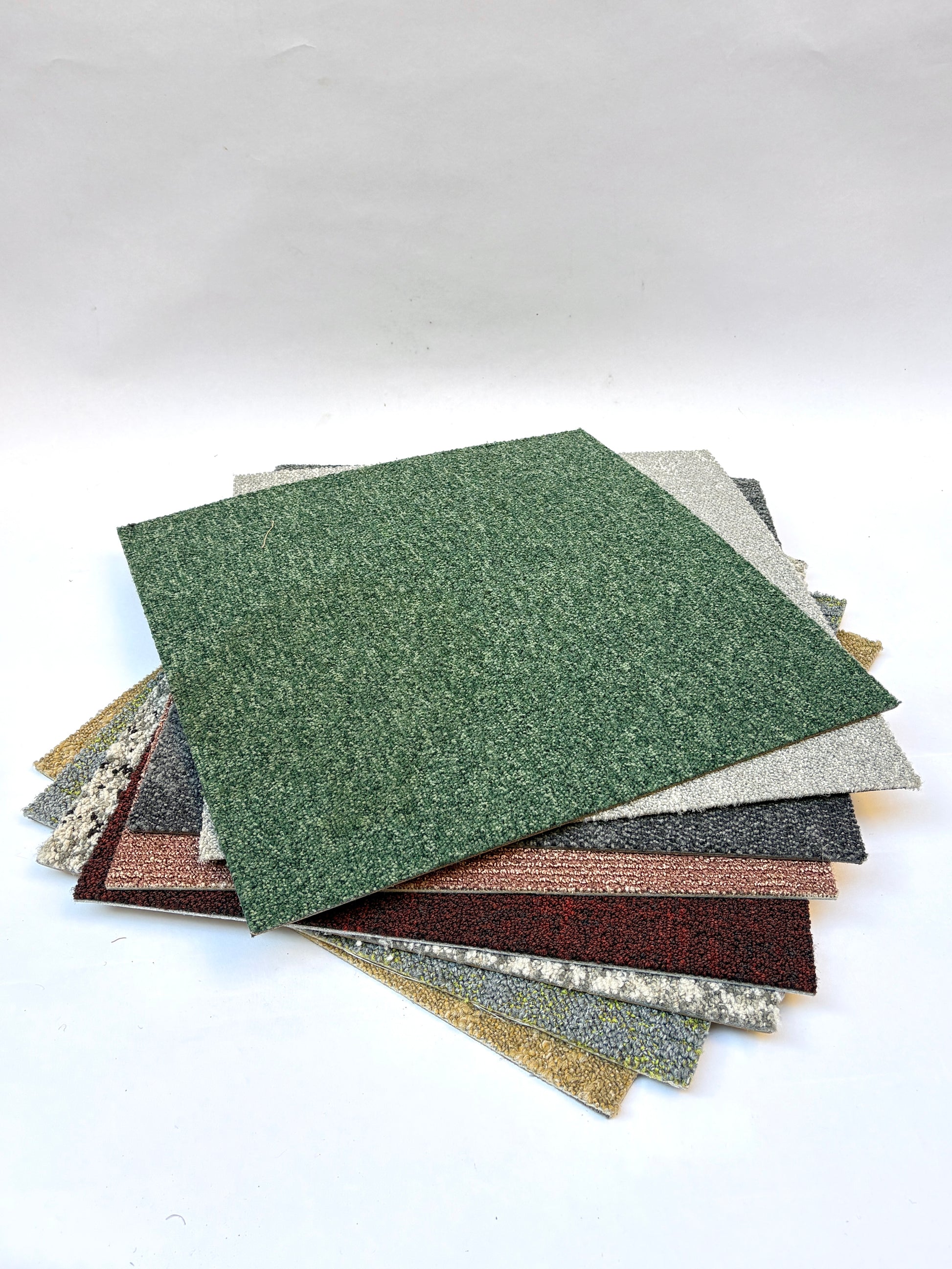 Collection of large square pieces of carpet samples in various colours 
