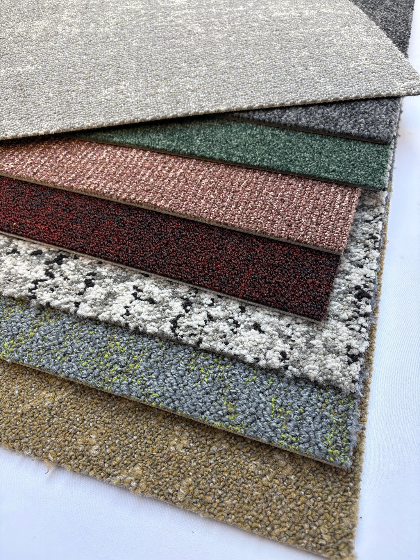 Collection of large square pieces of carpet samples in various colours 