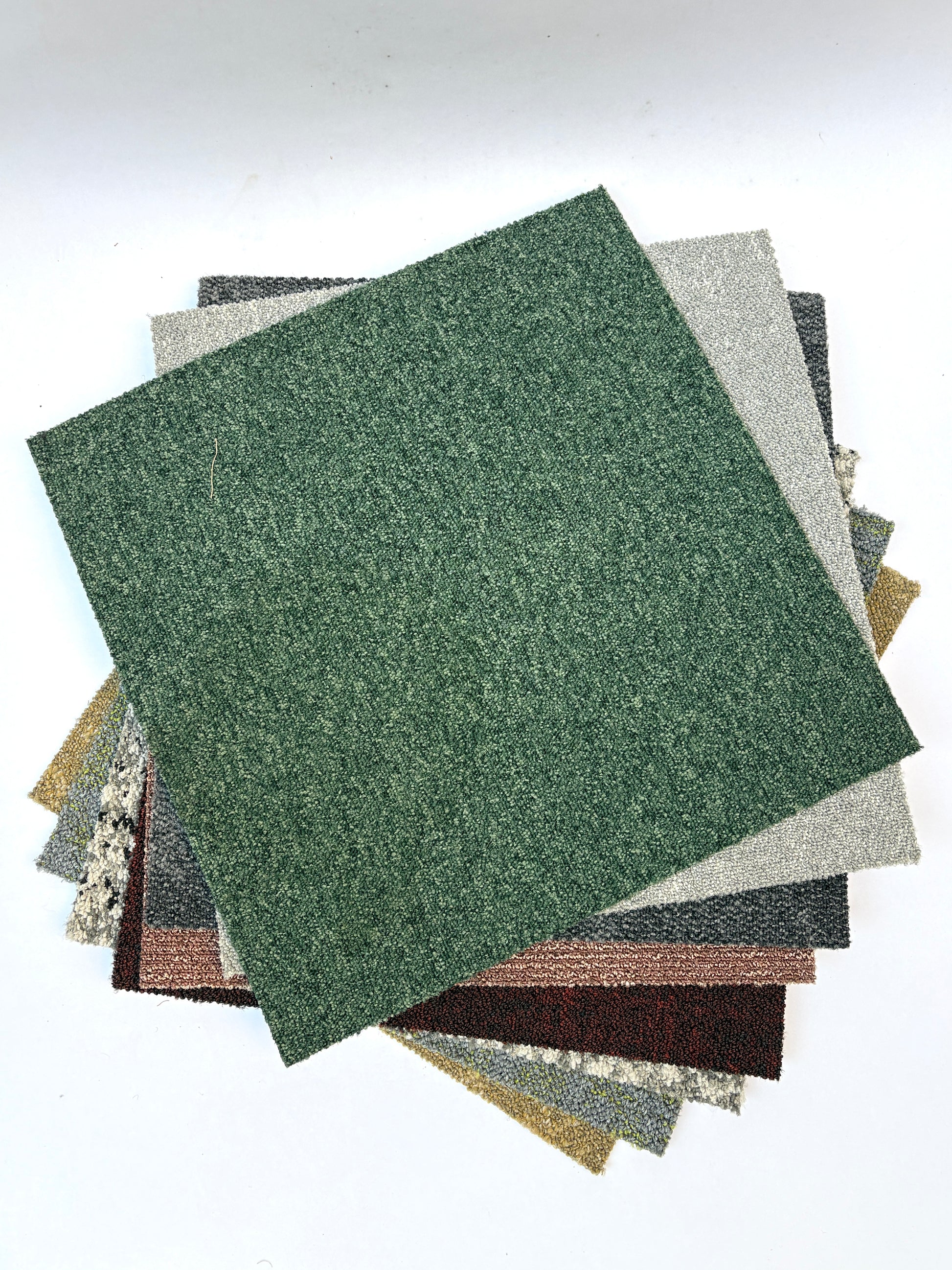 Collection of large square pieces of carpet samples in various colours 