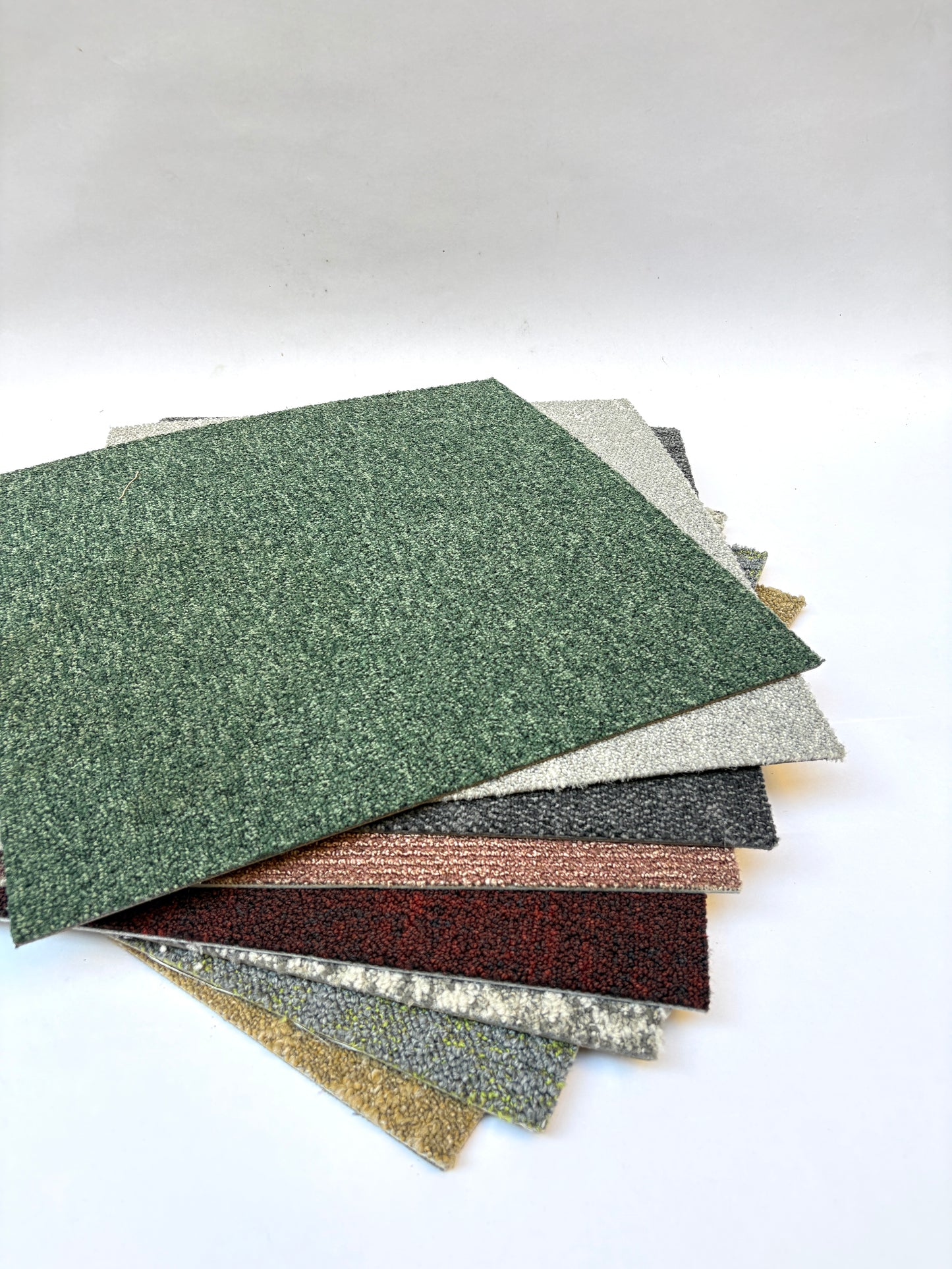Collection of large square pieces of carpet samples in various colours 