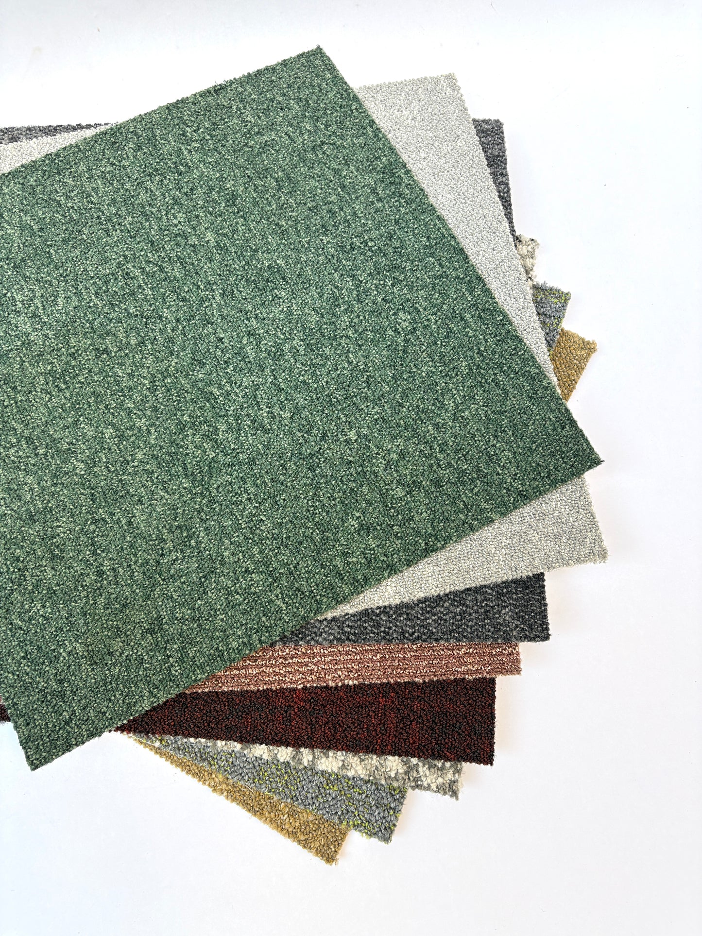 Collection of large square pieces of carpet samples in various colours 