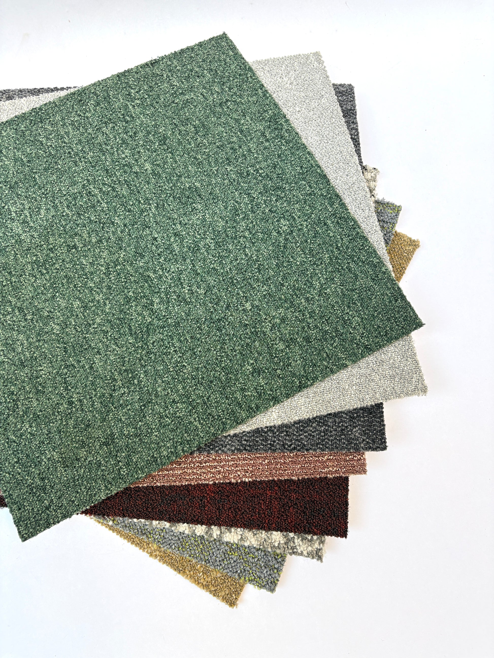 Collection of large square pieces of carpet samples in various colours 