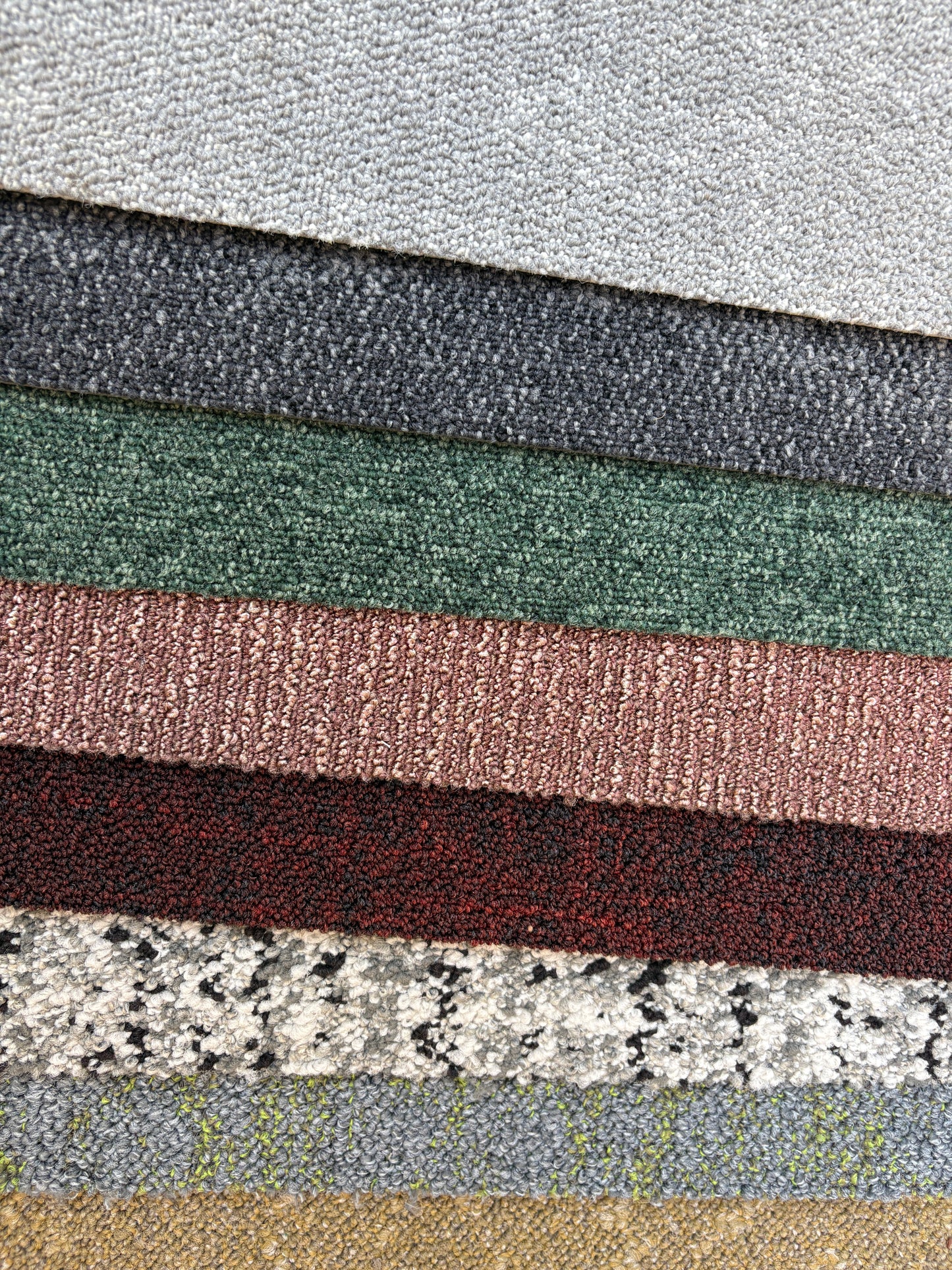 Collection of large square pieces of carpet samples in various colours 