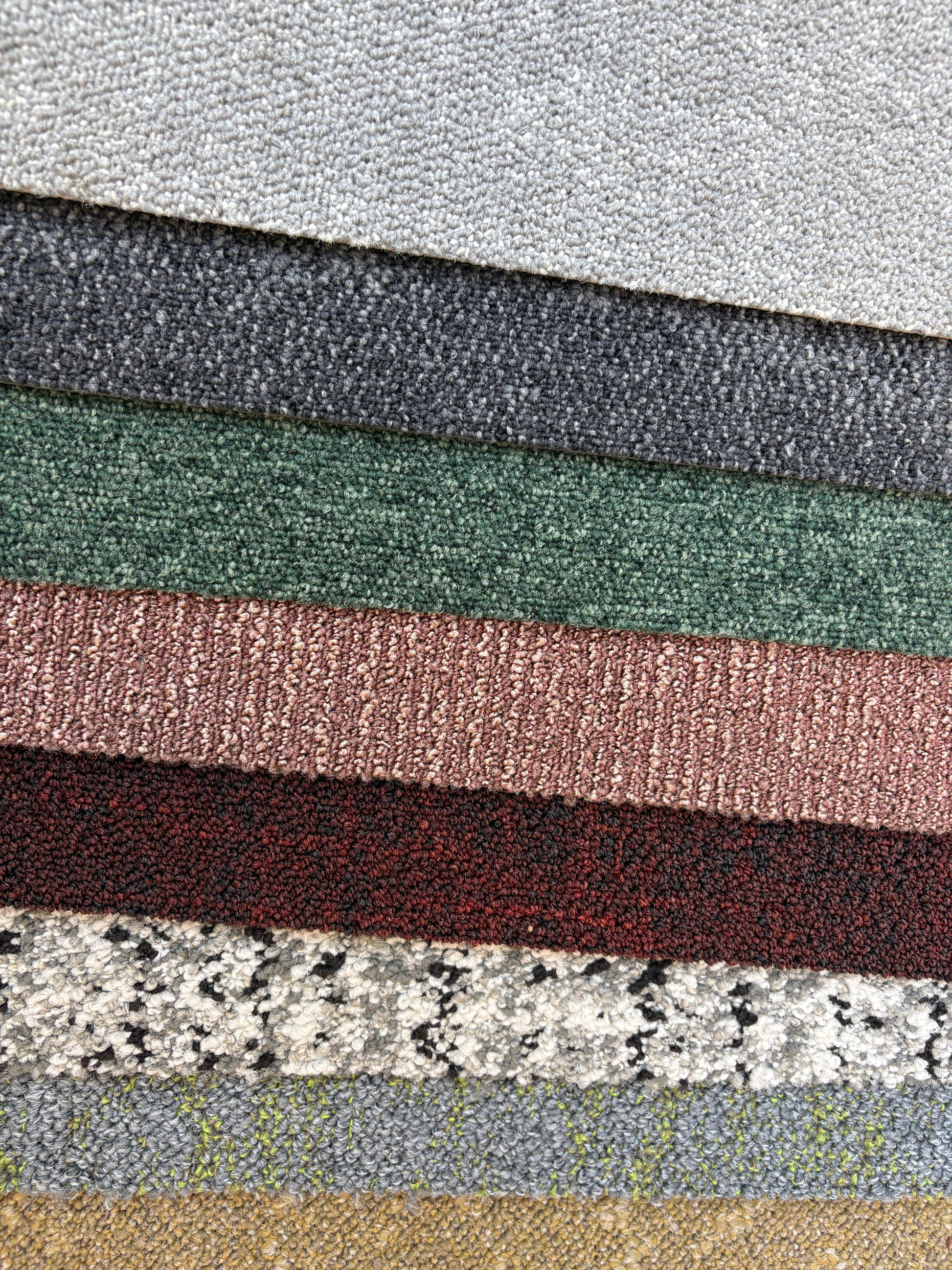 Collection of large square pieces of carpet samples in various colours 