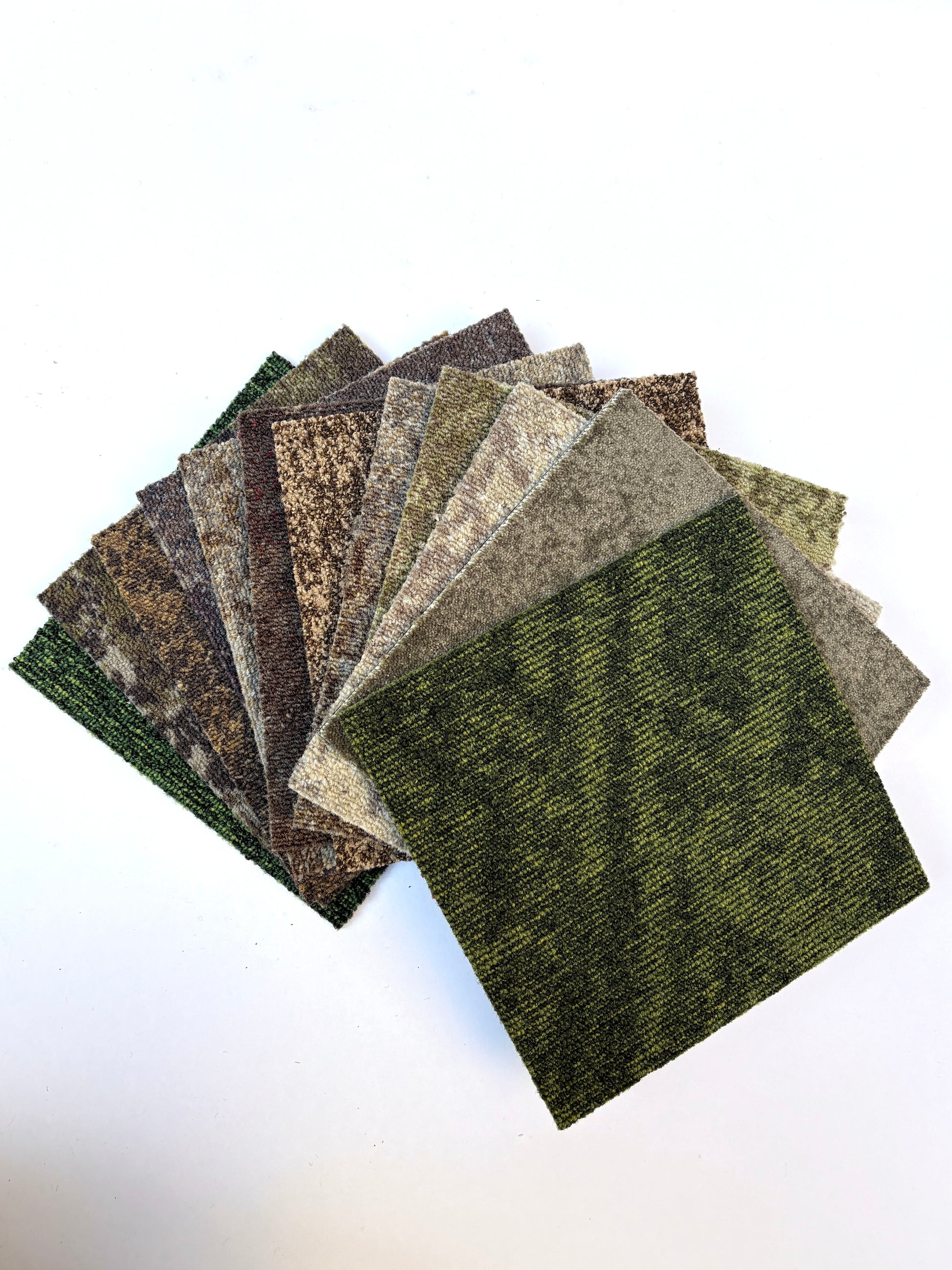 Square sample boards are stacked with one light grey piece on top