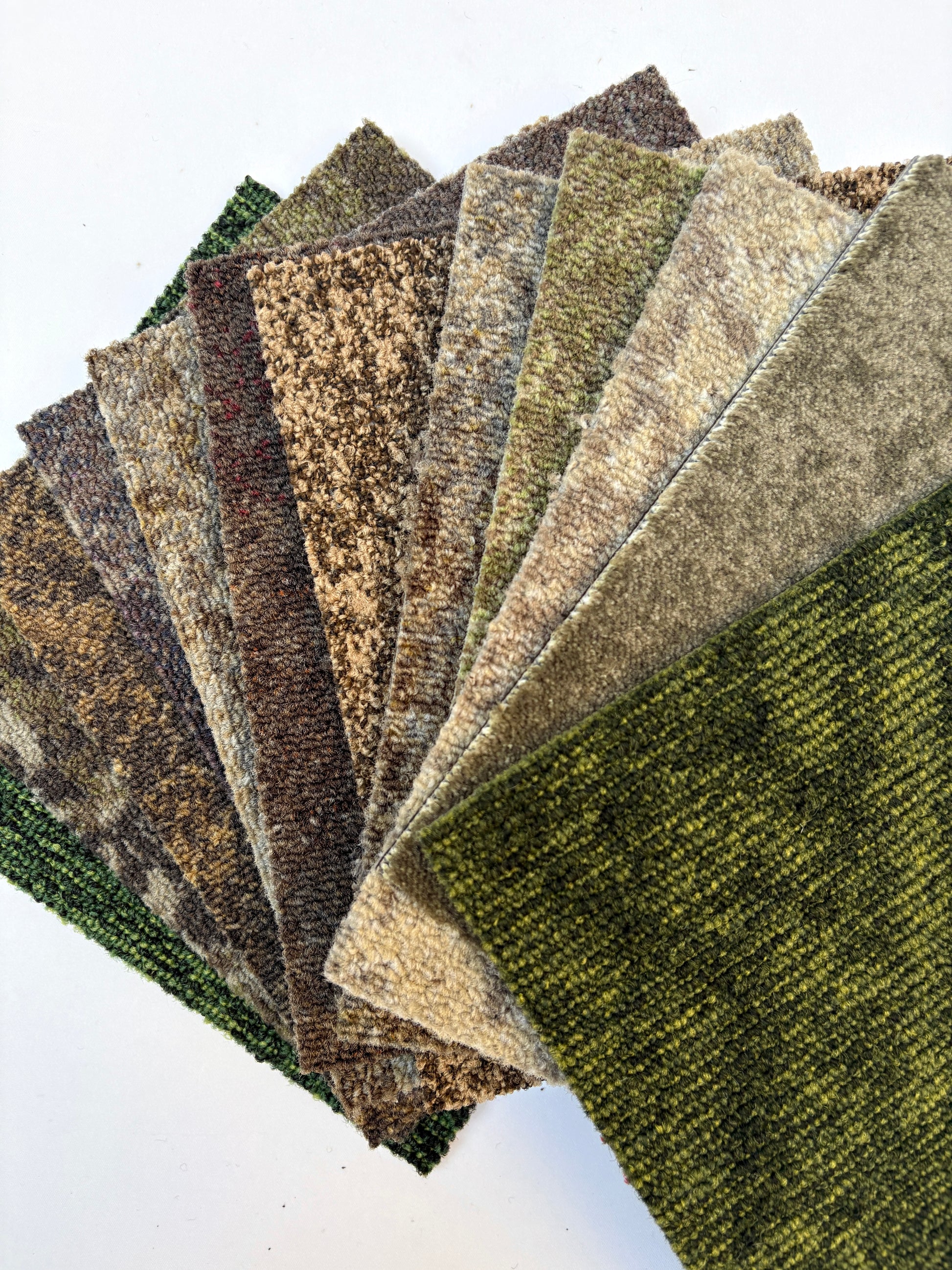 Textured surface samples are fanned out in mixed green and brown tones