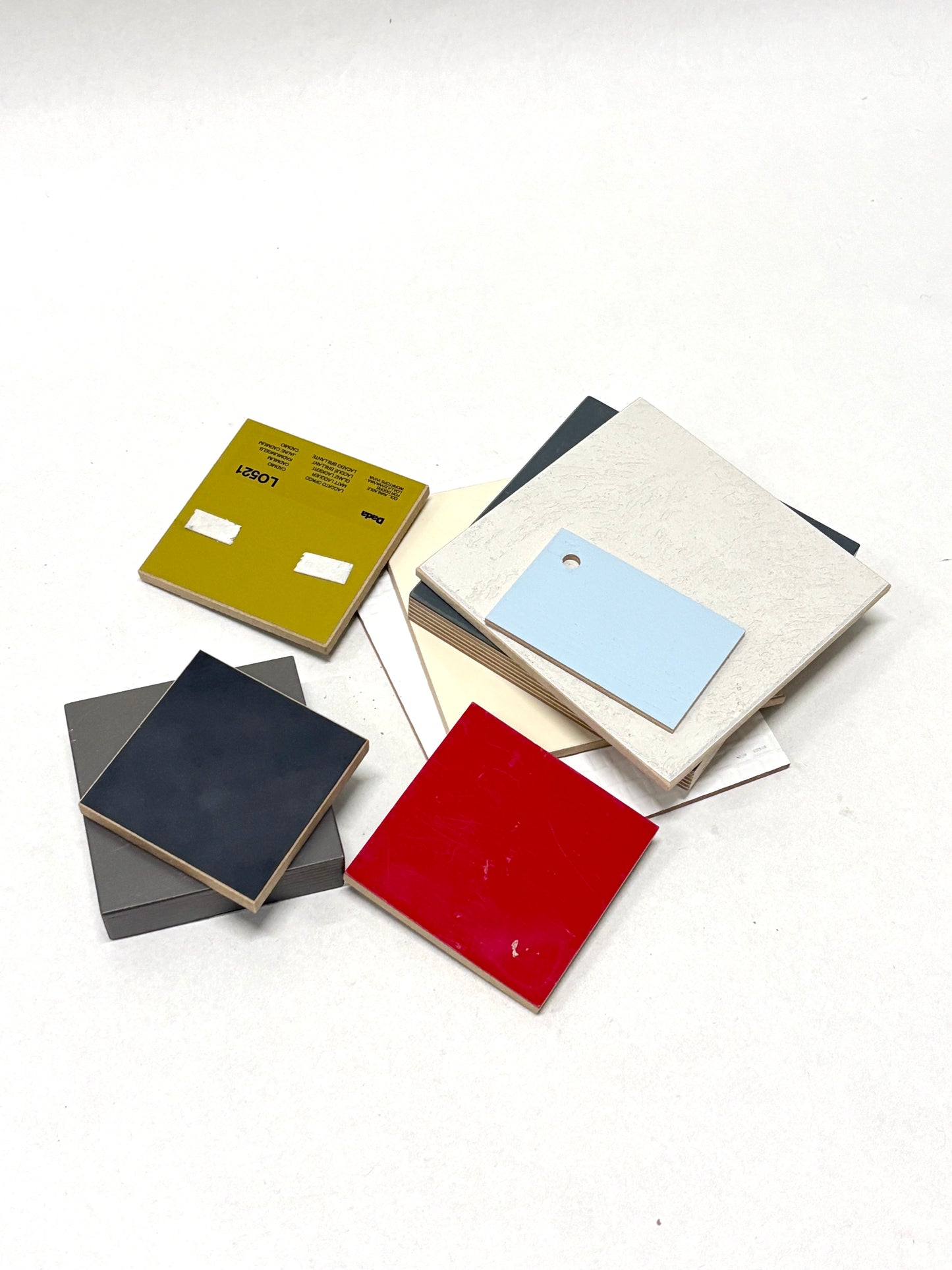 Stack of colour-coated wood samples in various sizes 