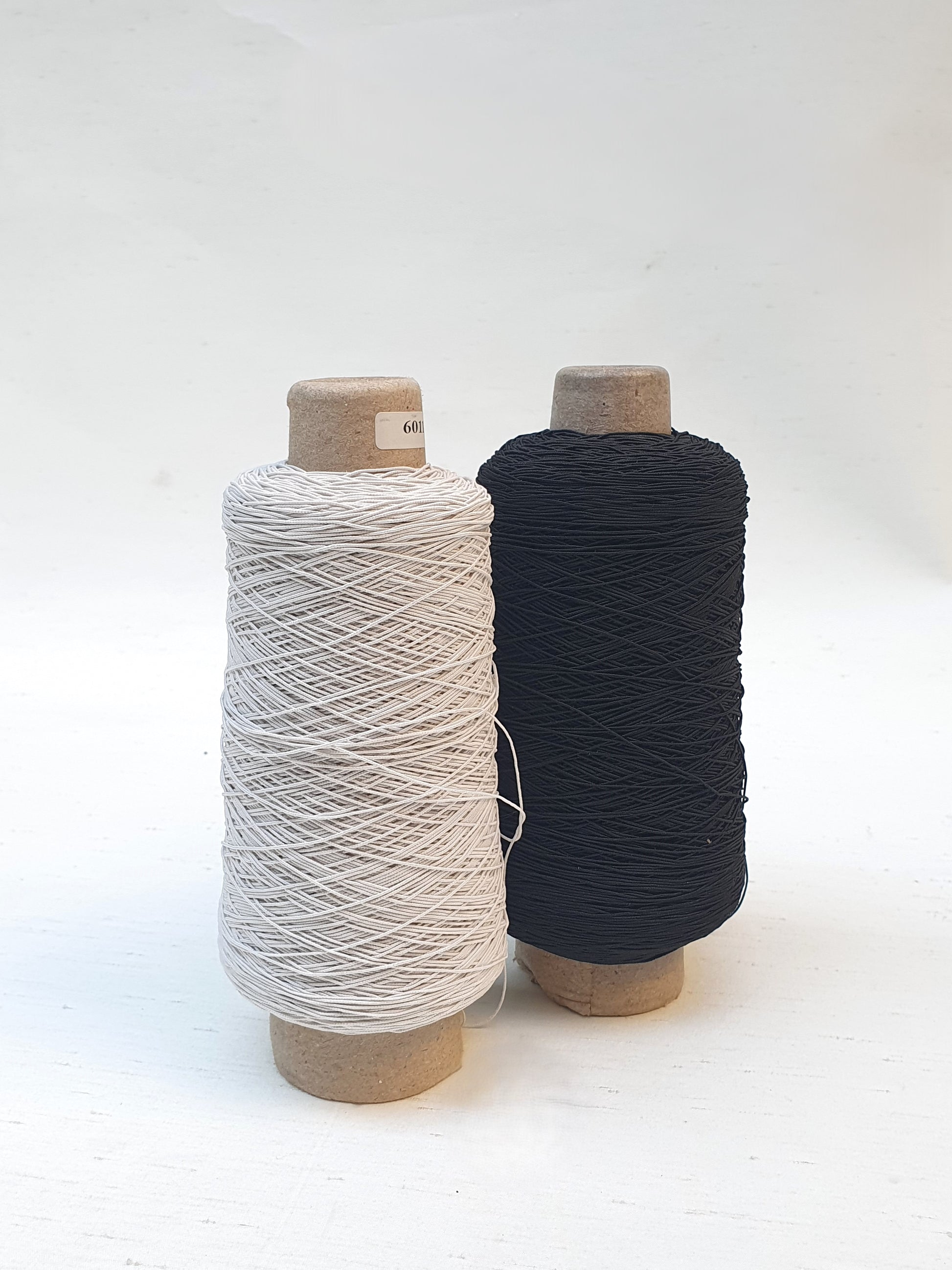 Two elastic cord rolls in black and white 