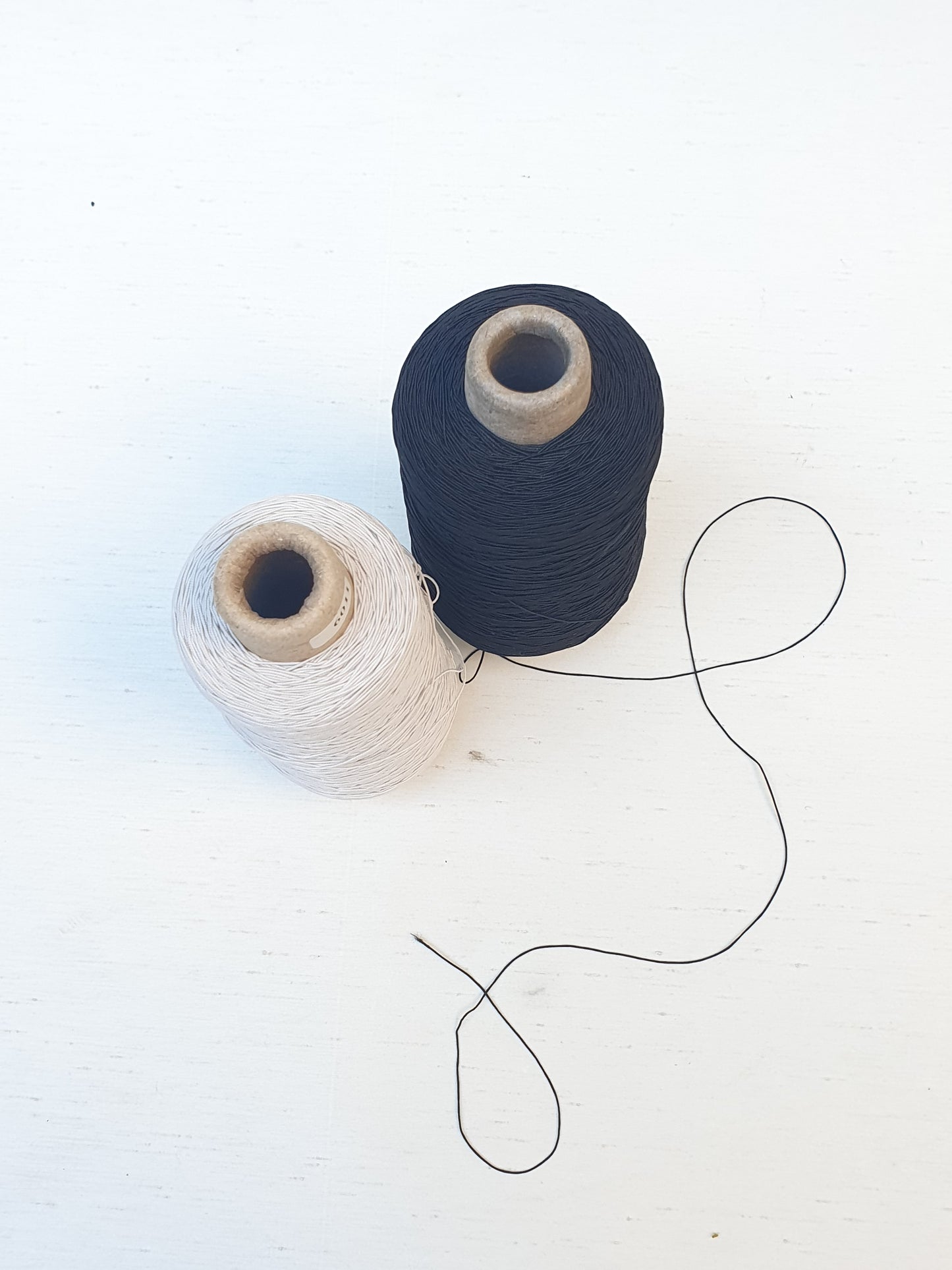 Two elastic cord rolls in black and white 
