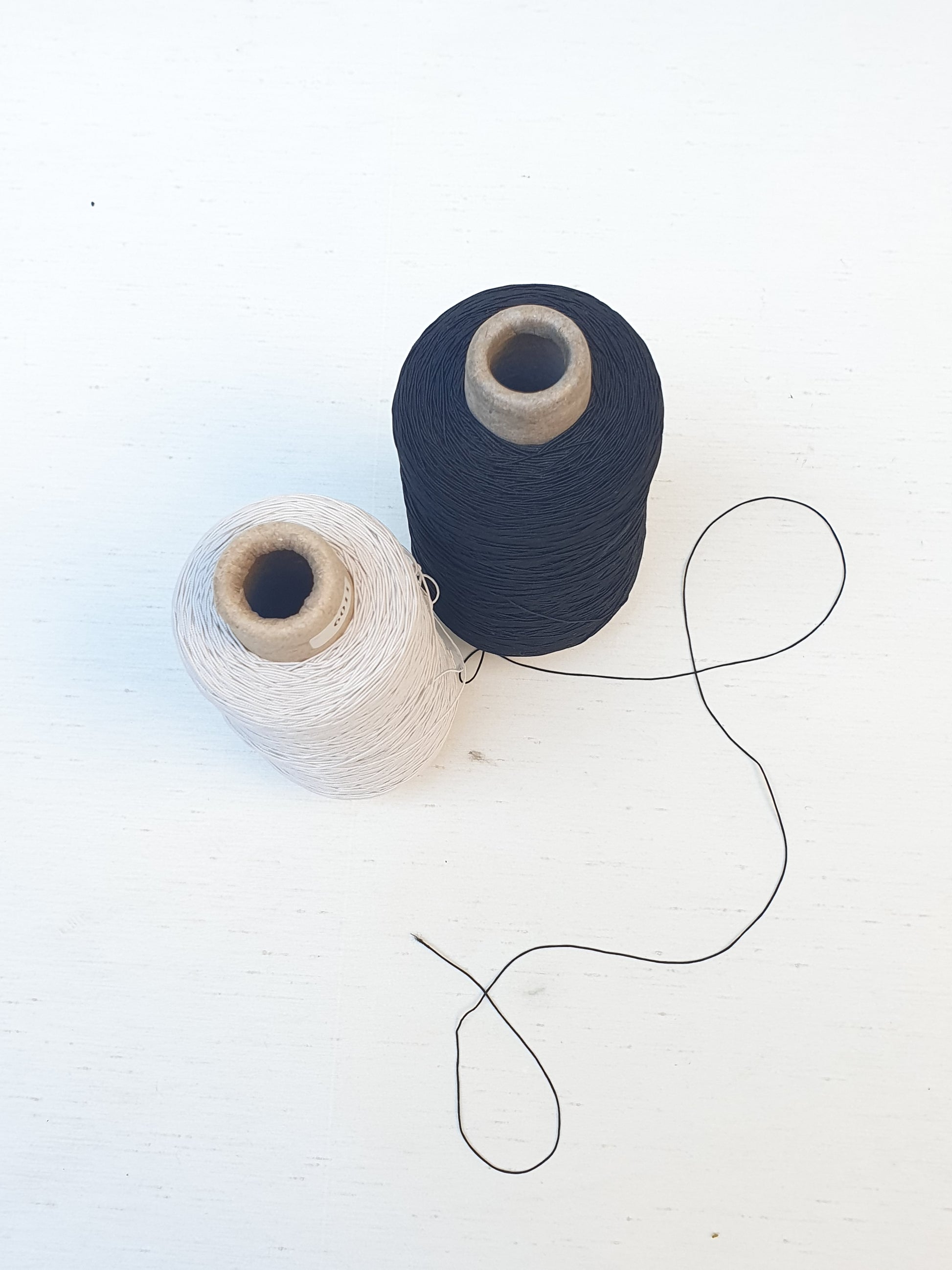 Two elastic cord rolls in black and white 