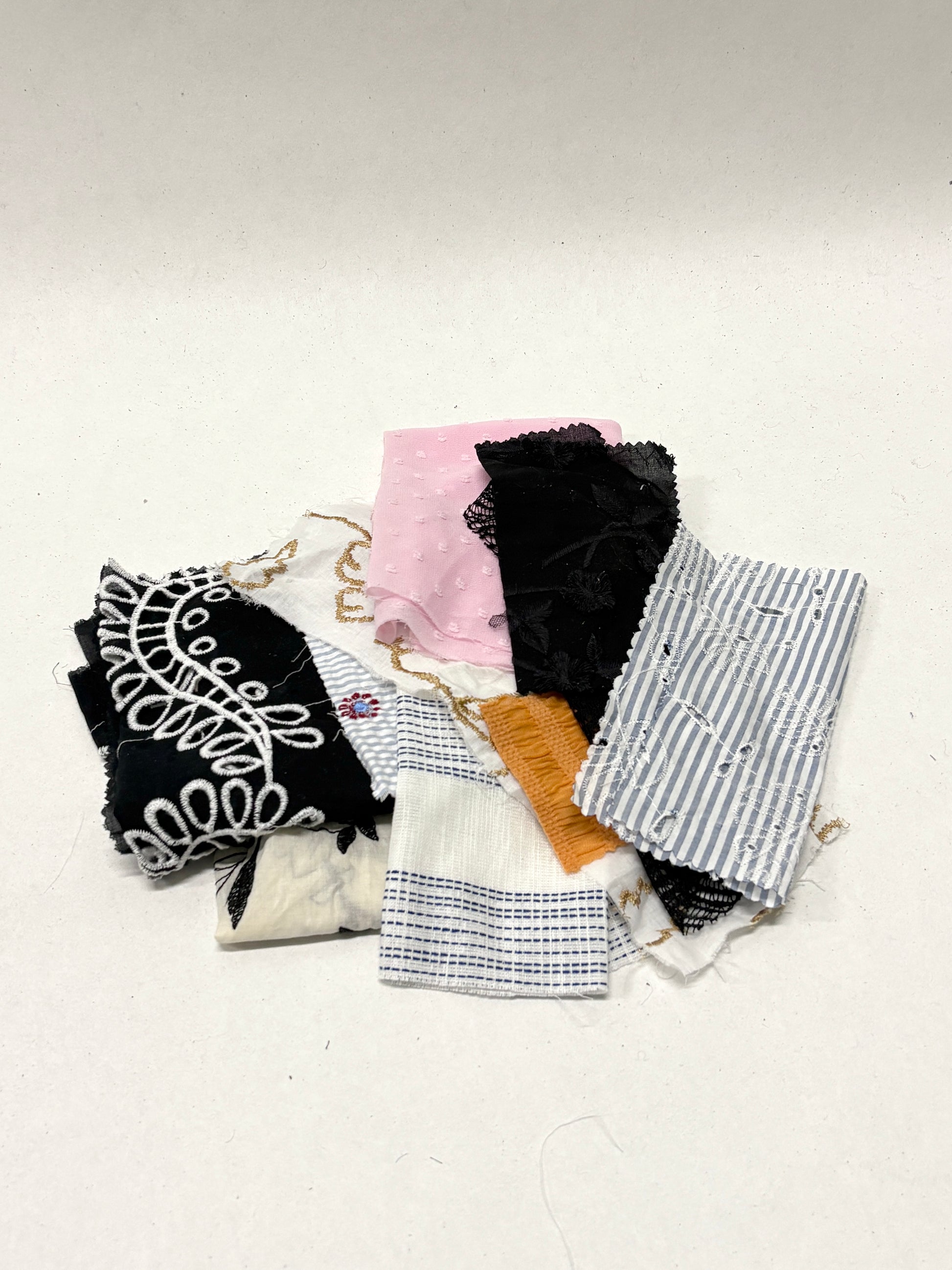 Collection of decorative lace fabric offcuts in various colours 