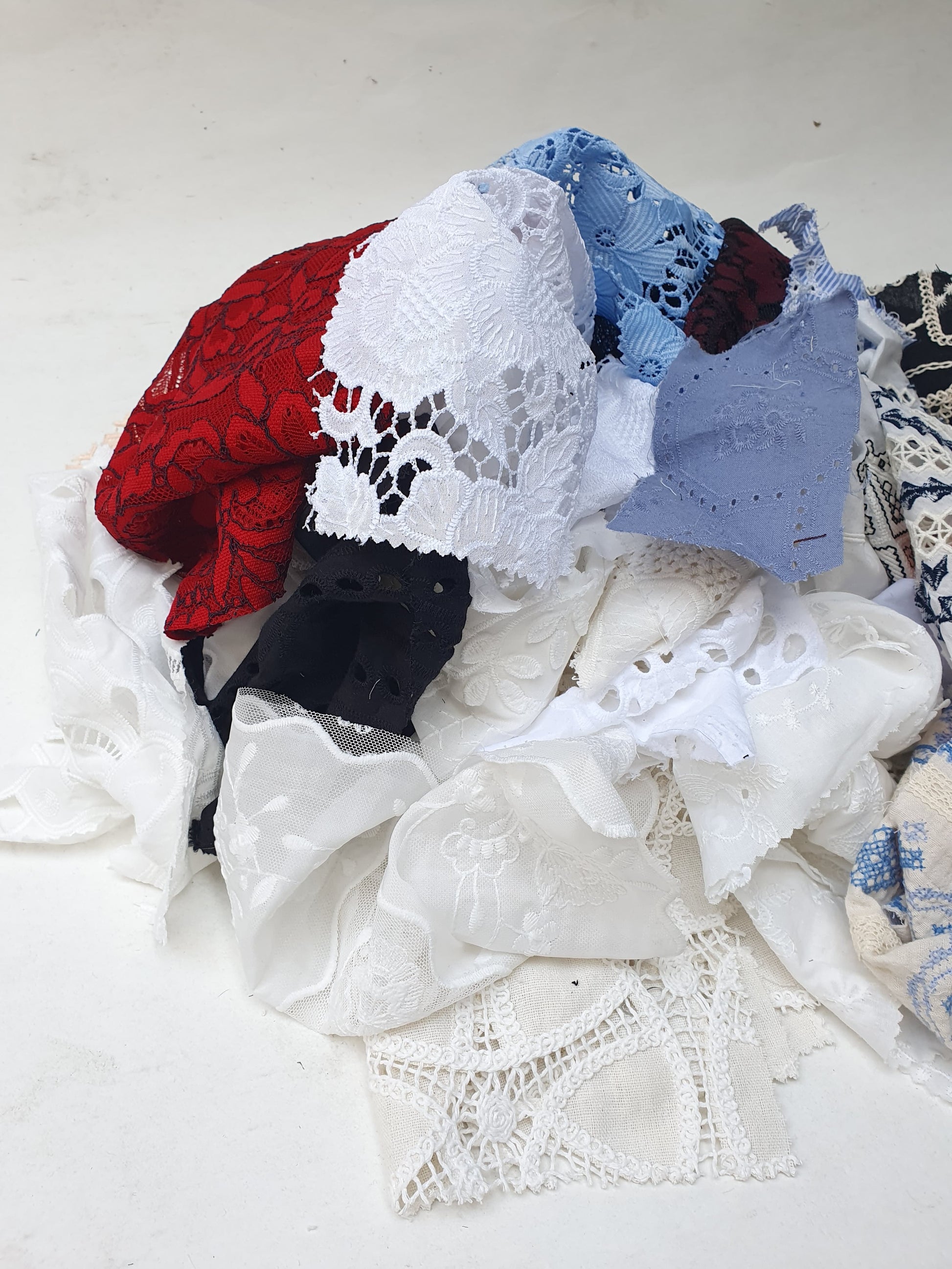 Collection of decorative lace fabric offcuts in various colours 
