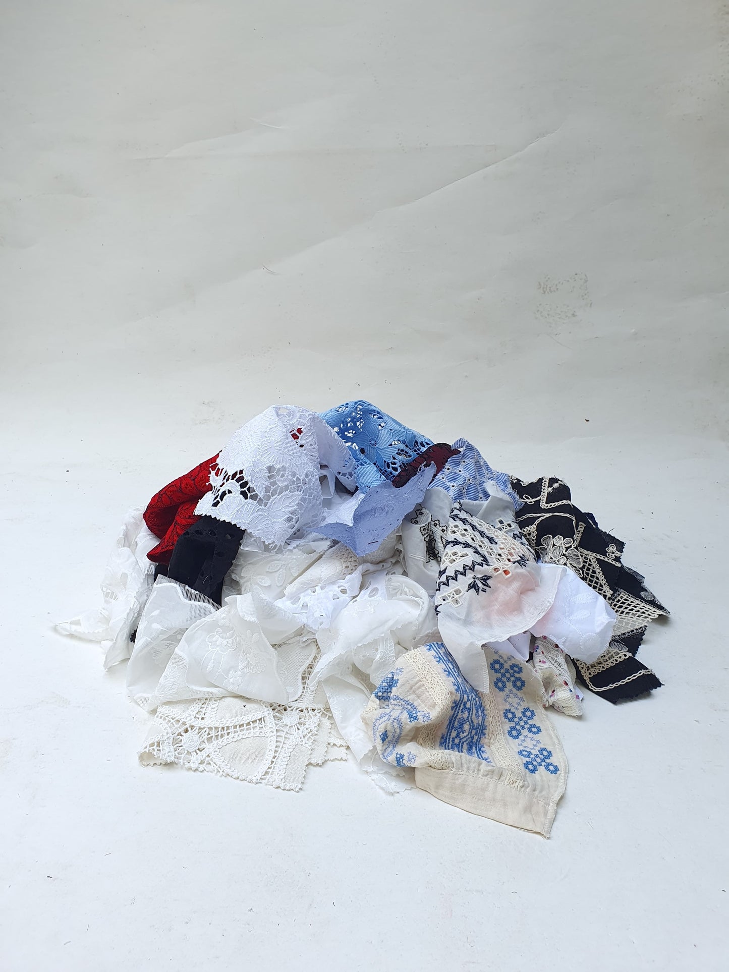 Collection of decorative lace fabric offcuts in various colours 