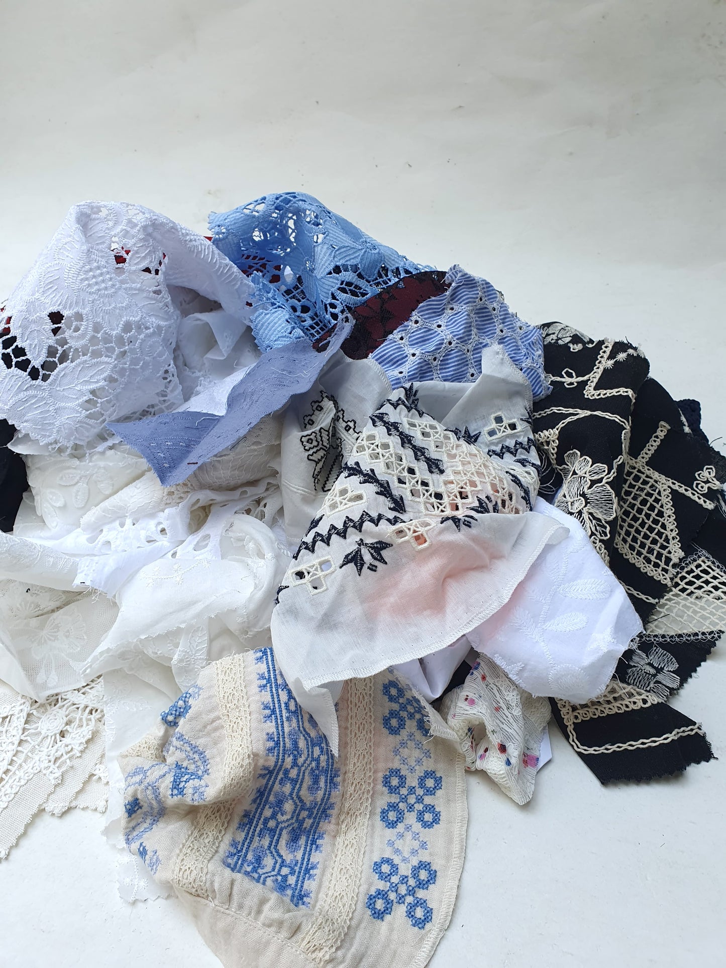 Collection of decorative lace fabric offcuts in various colours 