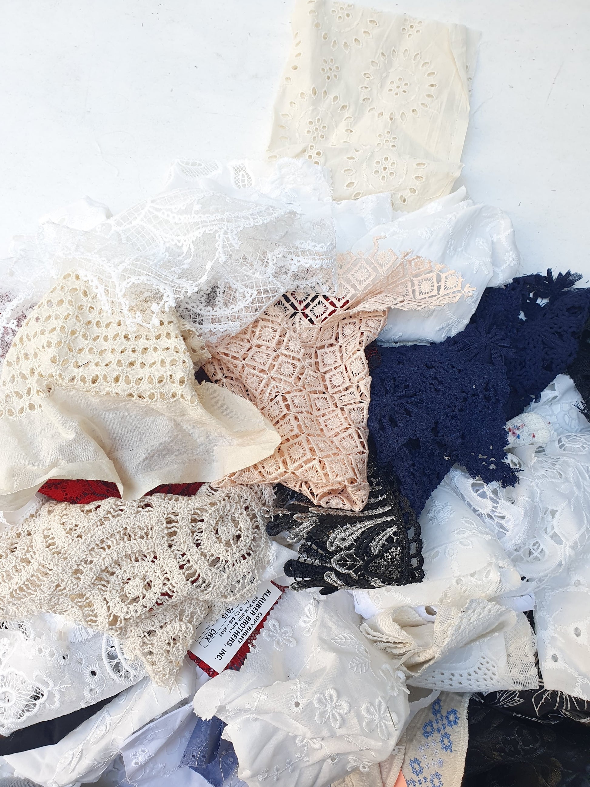 Collection of decorative lace fabric offcuts in various colours 