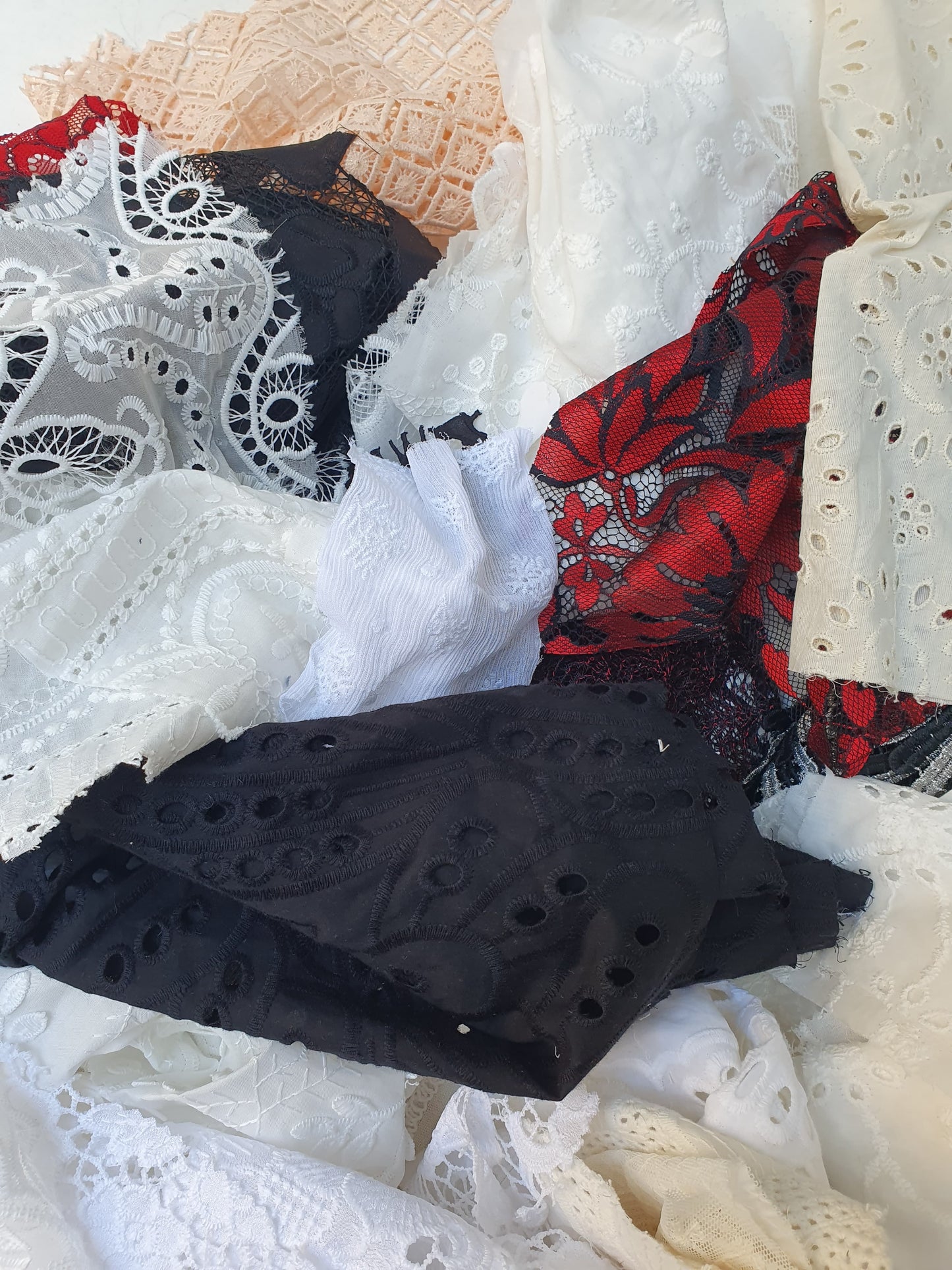 Collection of decorative lace fabric offcuts in various colours 