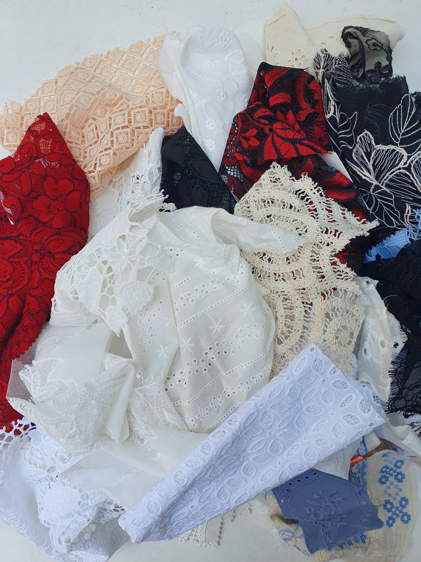 Collection of decorative lace fabric offcuts in various colours 