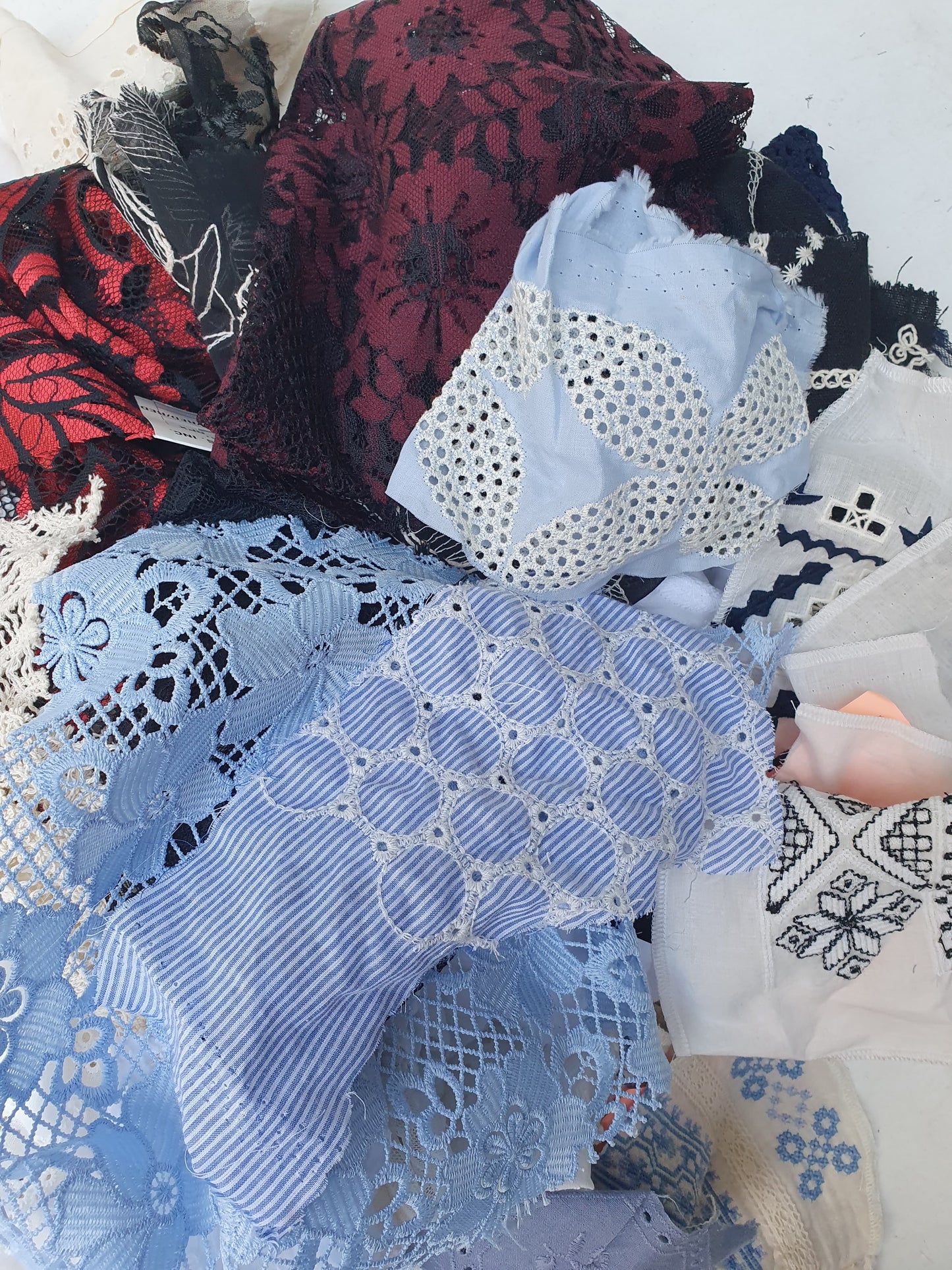 Collection of decorative lace fabric offcuts in various colours 
