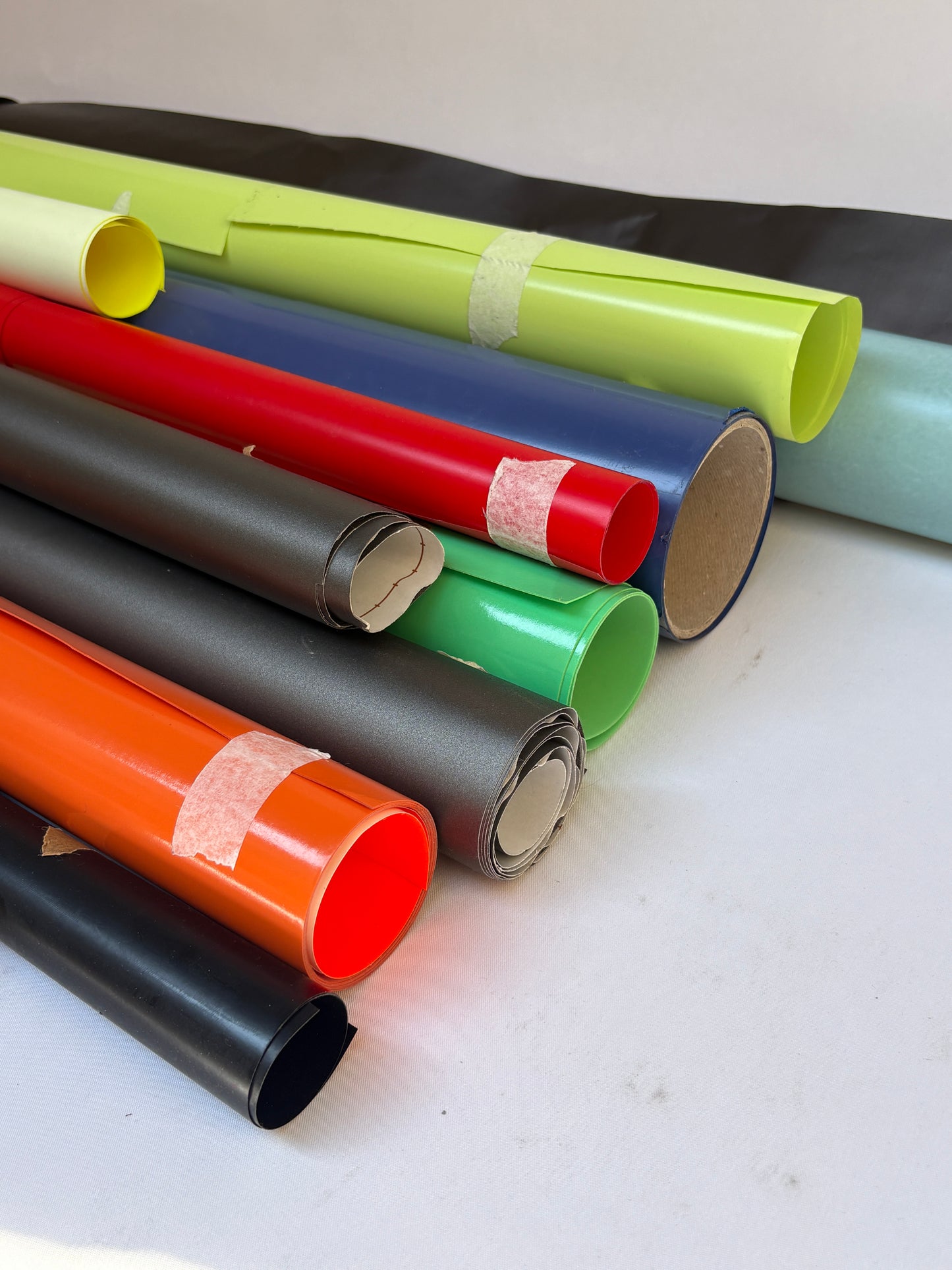 Collection of decorative paper vinyl rolls which are self-adhesive, in various colours 