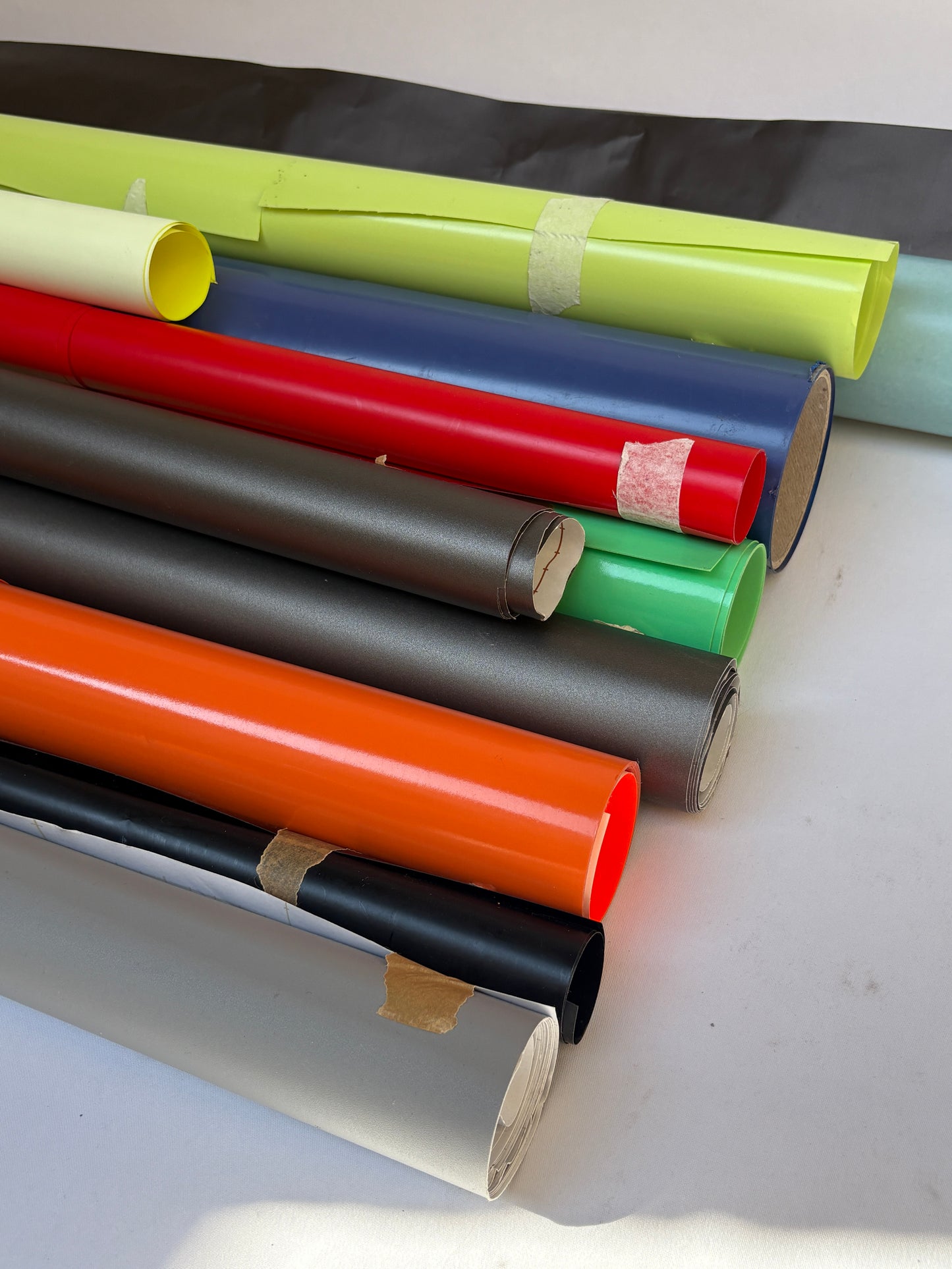 Collection of decorative paper vinyl rolls which are self-adhesive, in various colours 