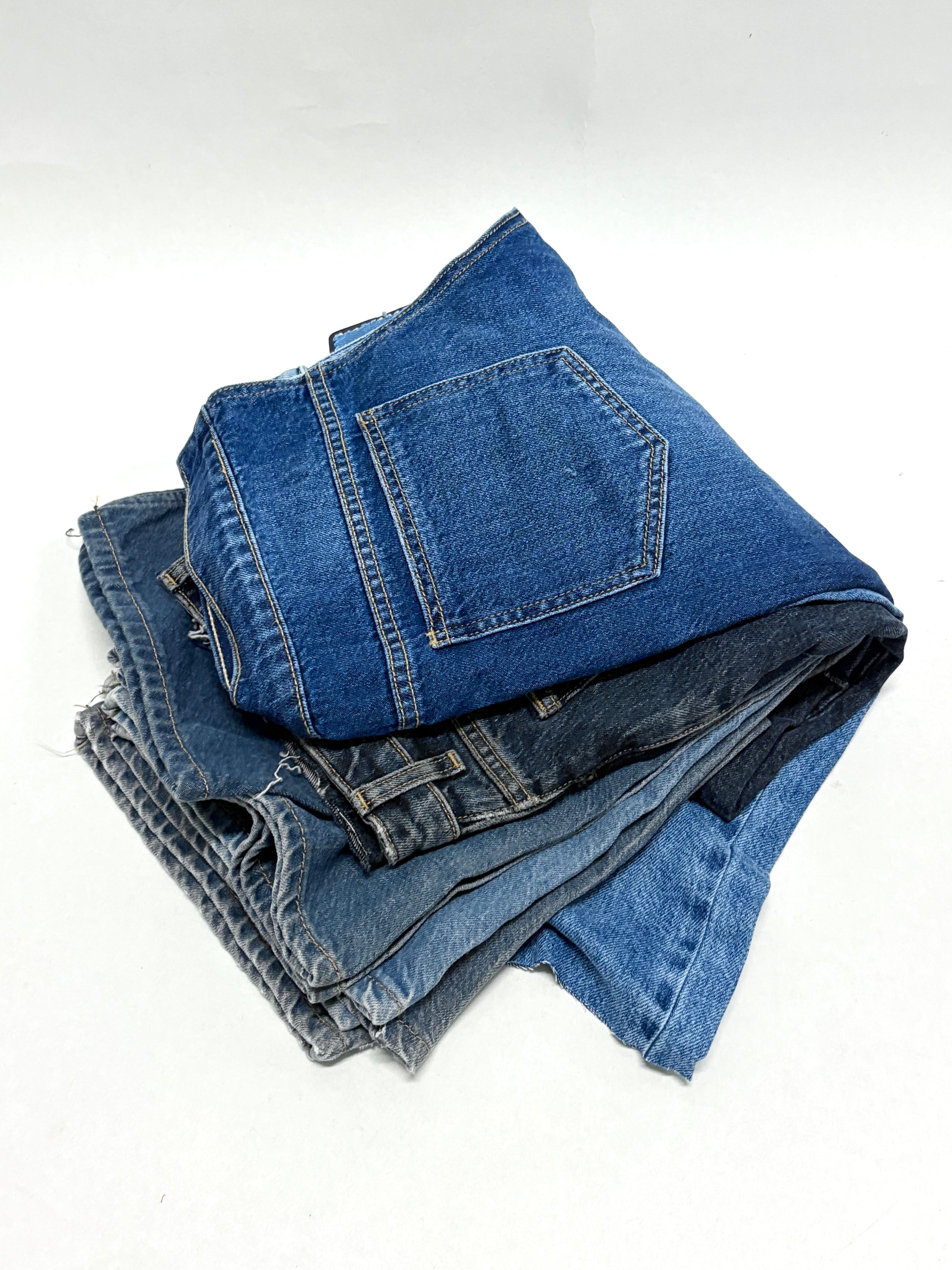 Stack of denim fabric samples with classic denim shades