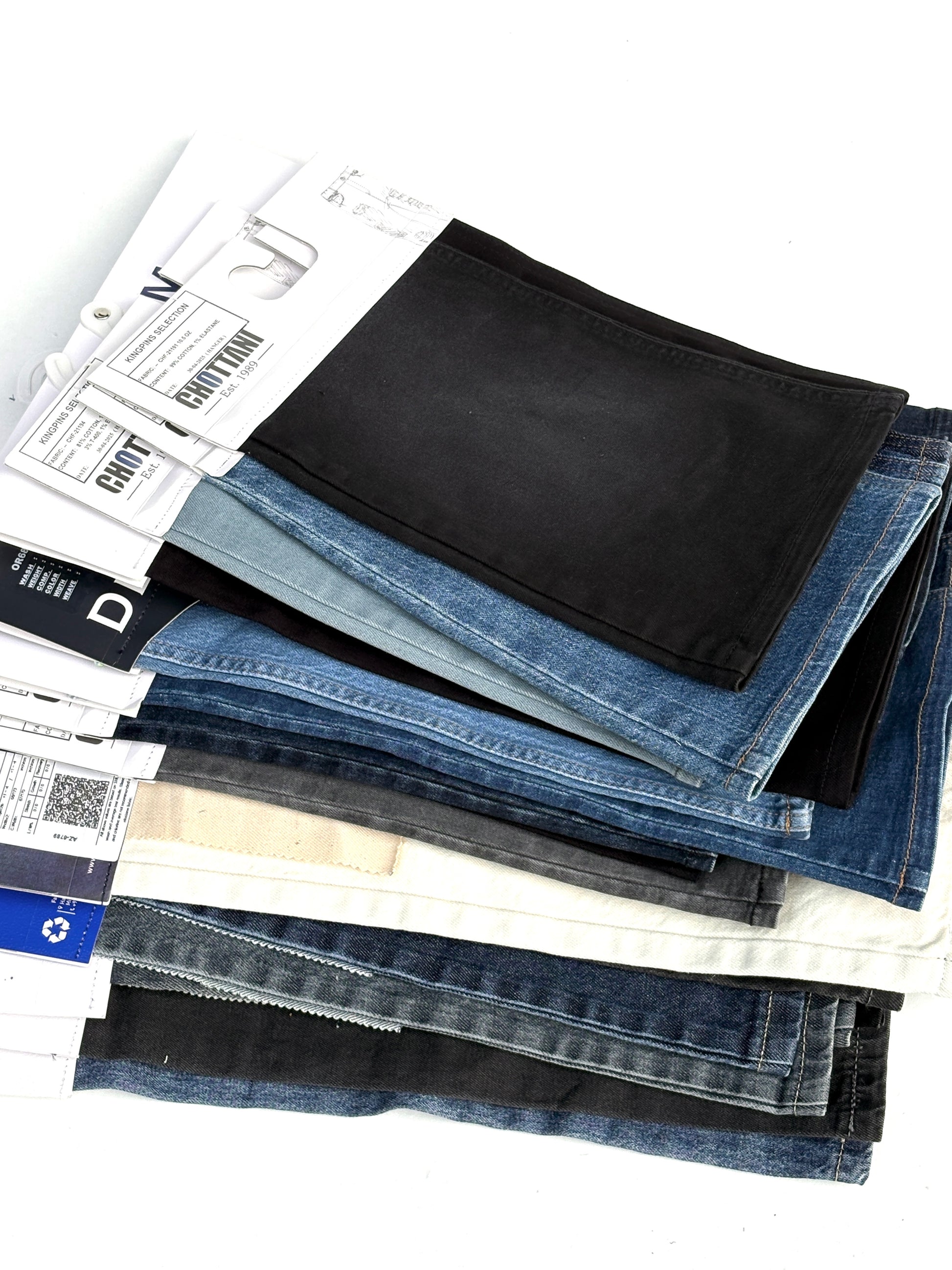 Stack of denim fabric samples with classic denim shades