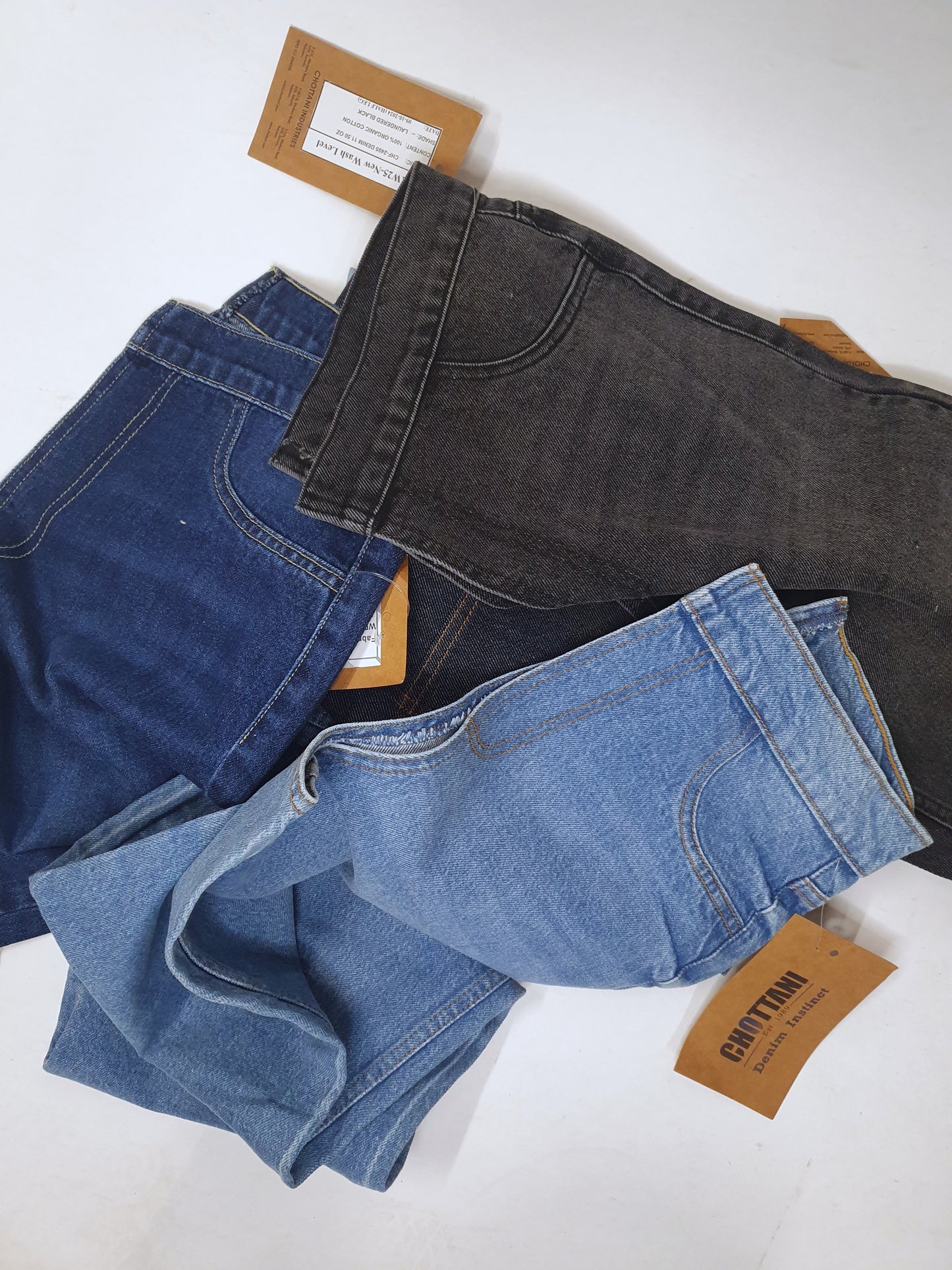Stack of denim fabric samples with classic denim shades