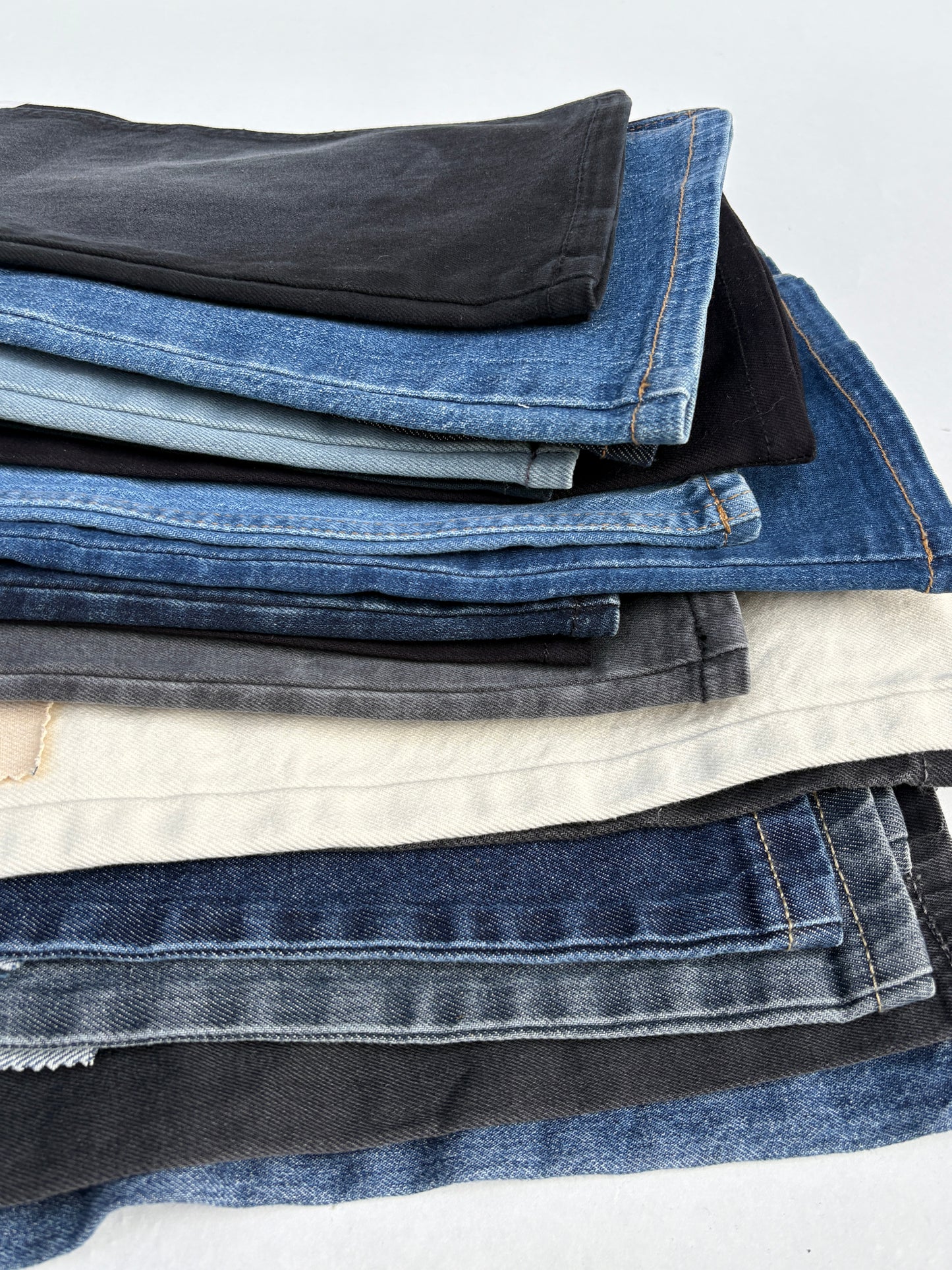Stack of denim fabric samples with classic denim shades