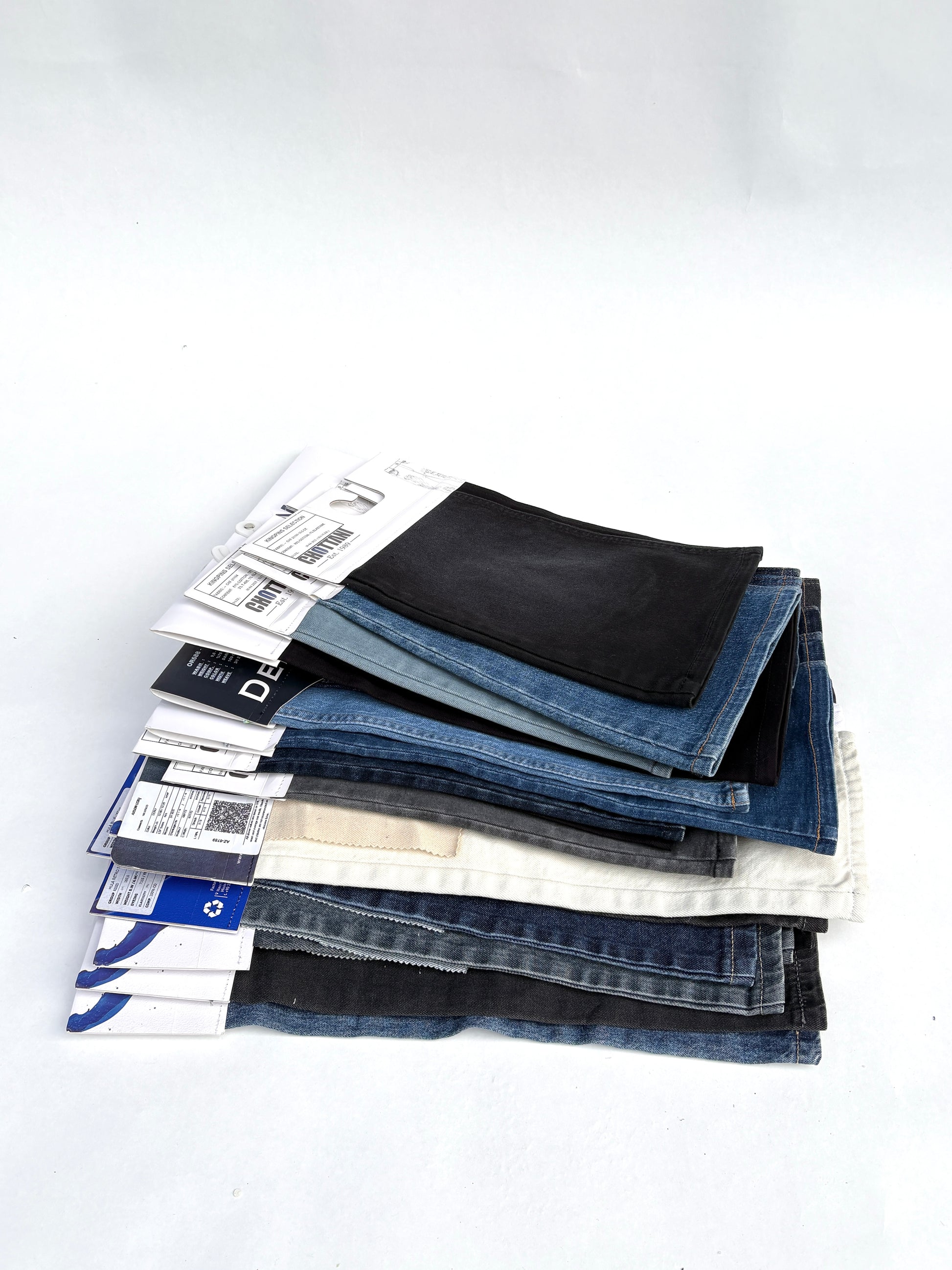 Stack of denim fabric samples with classic denim shades