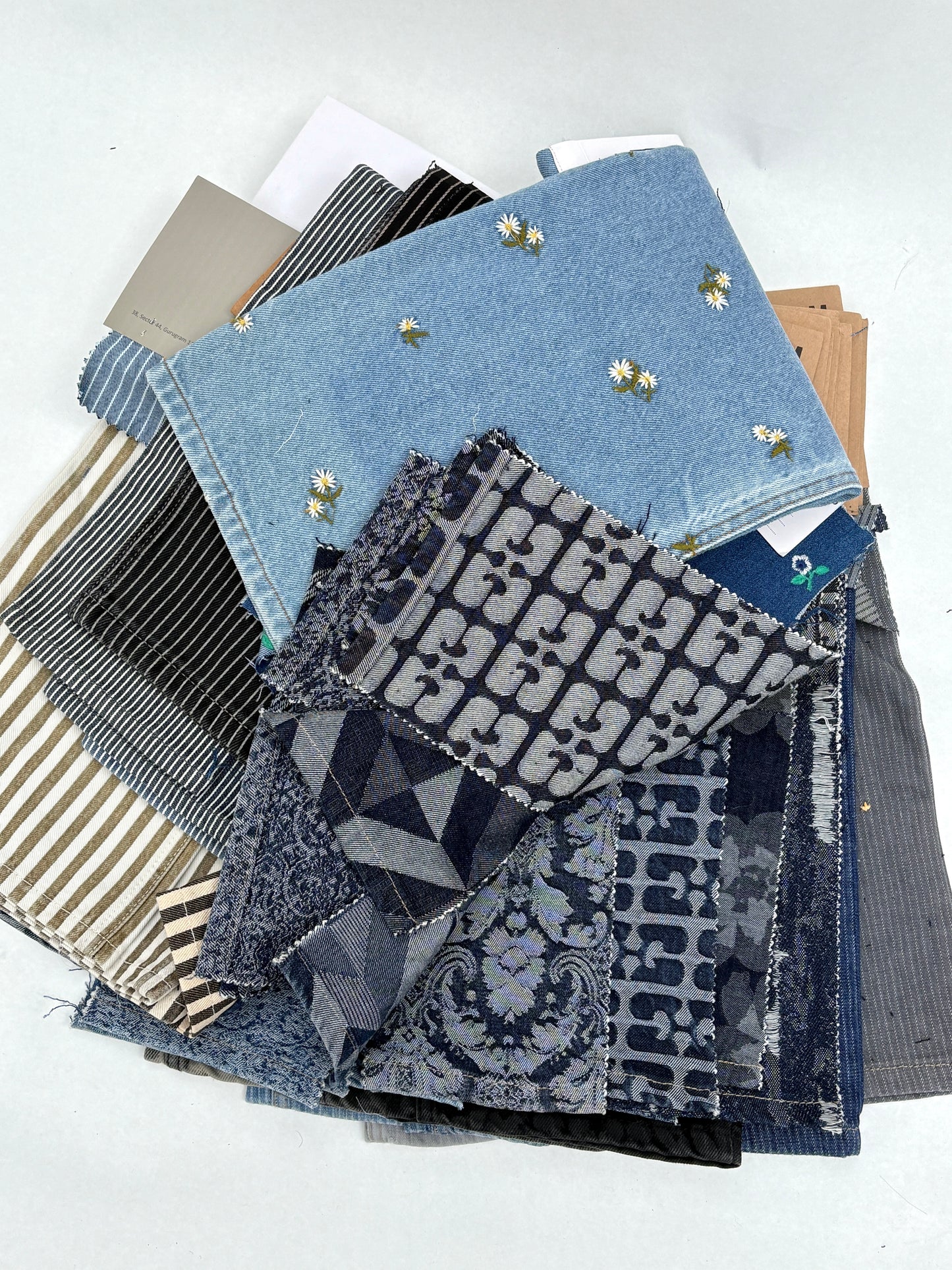 Collection of denim fabric swatches with various patterns