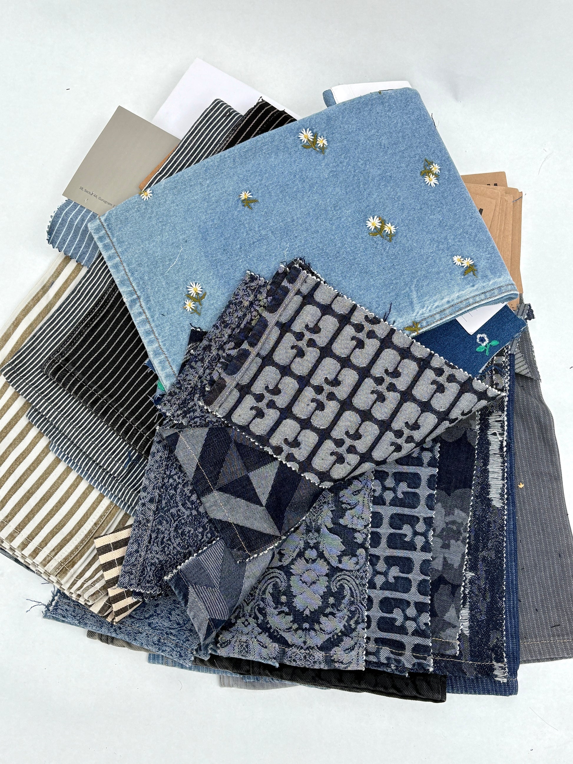 Collection of denim fabric swatches with various patterns