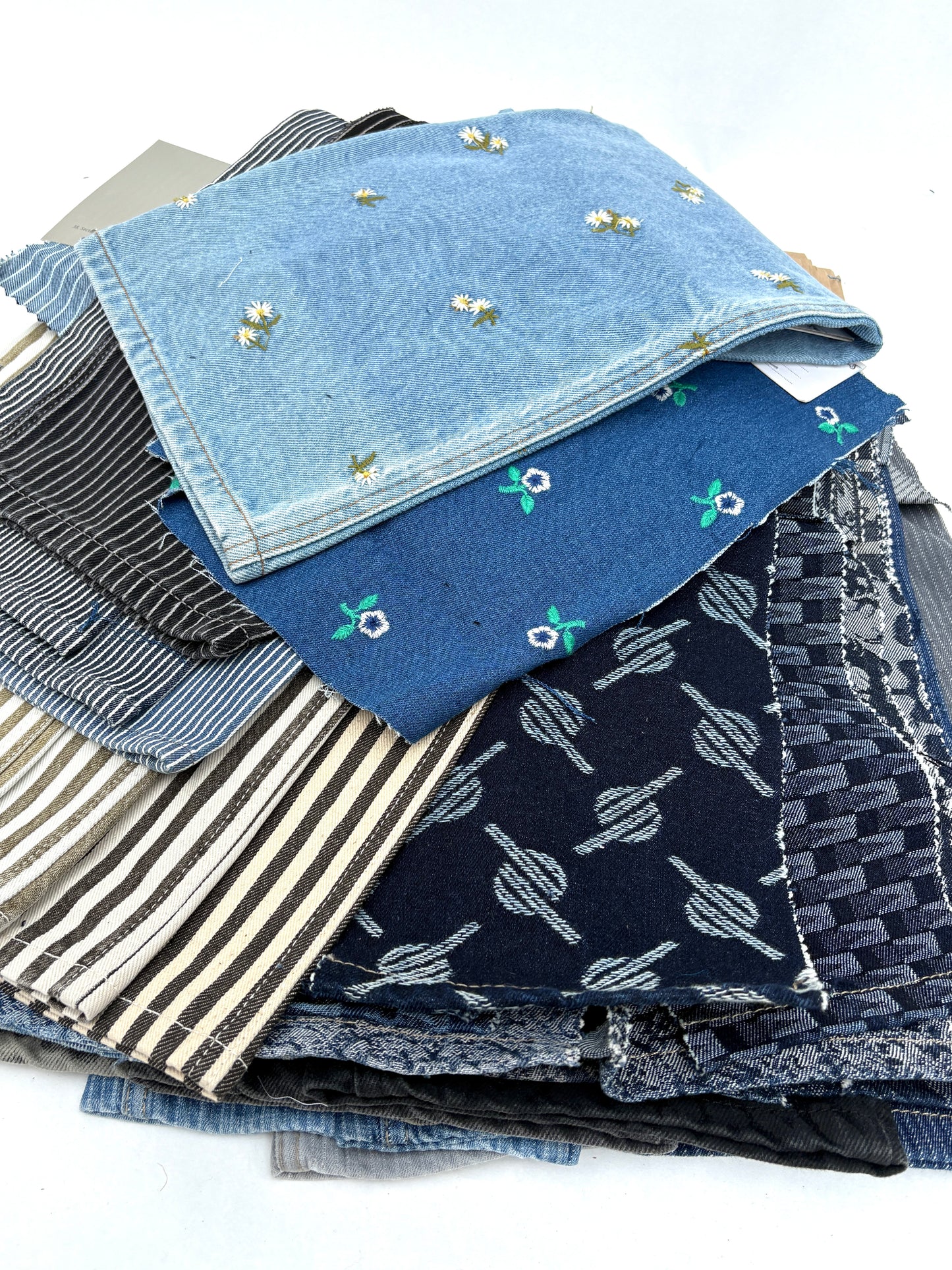 Collection of denim fabric swatches with various patterns