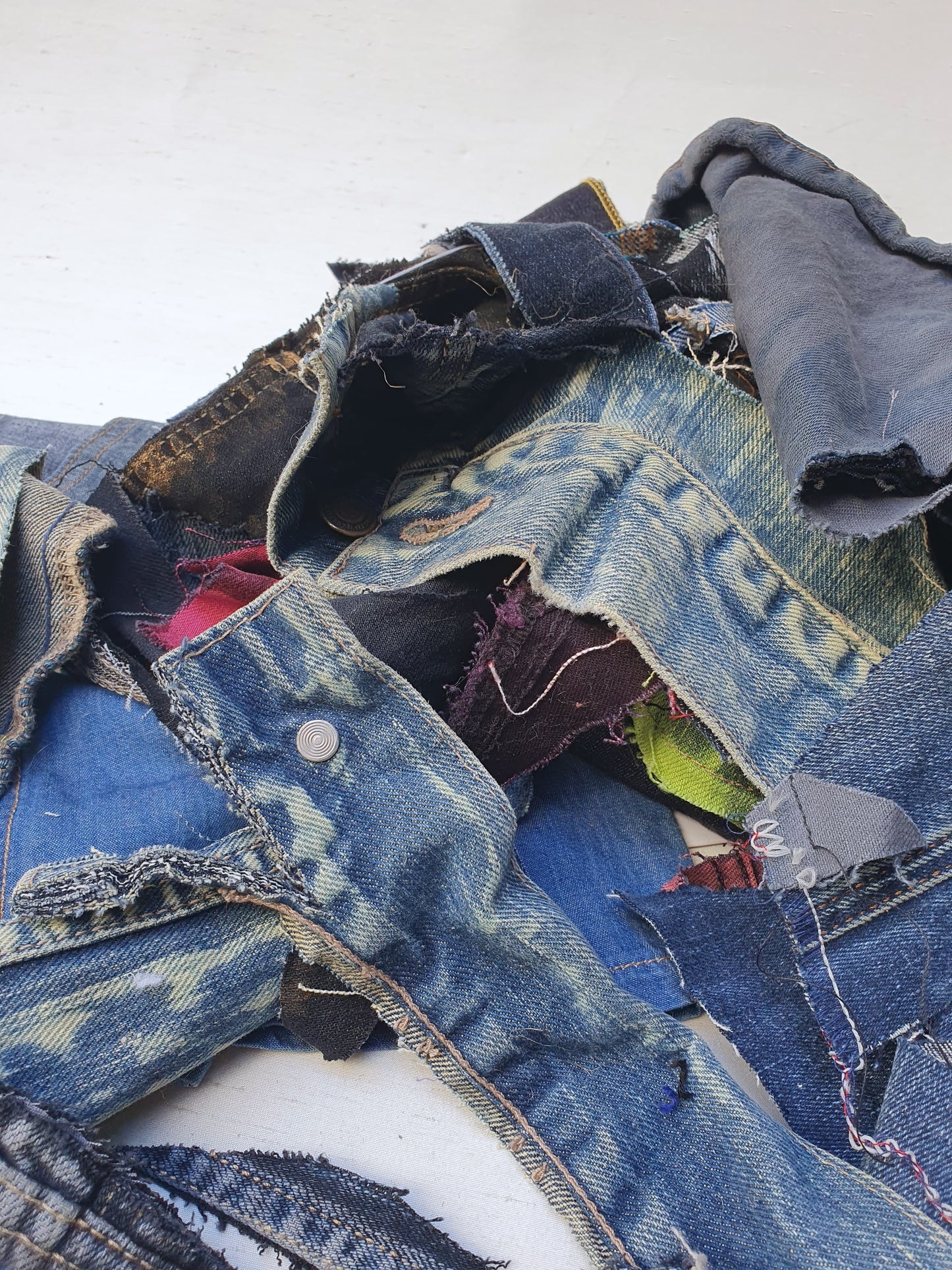 Stack of denim offcuts with various sizes