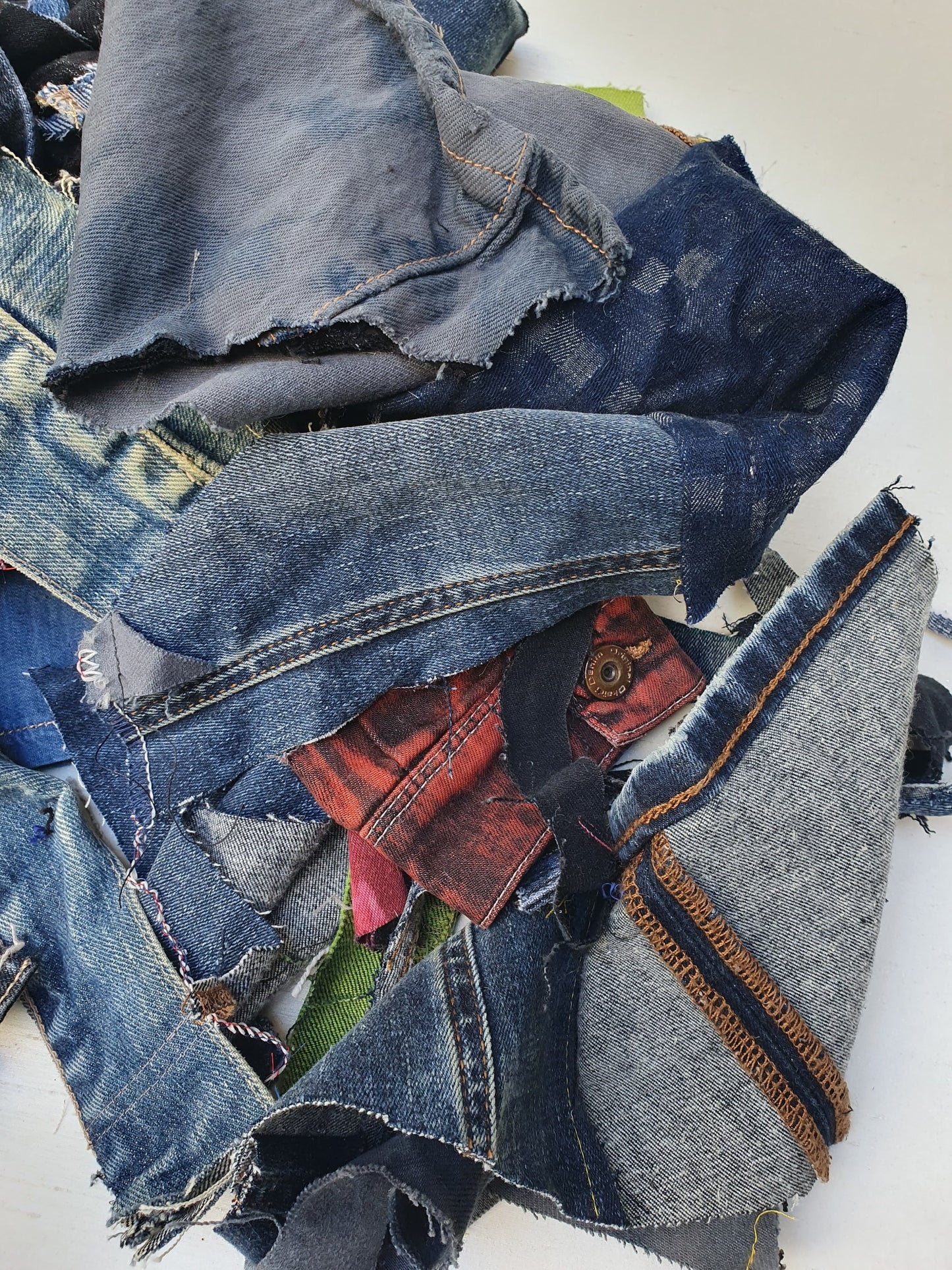 Stack of denim offcuts with various sizes