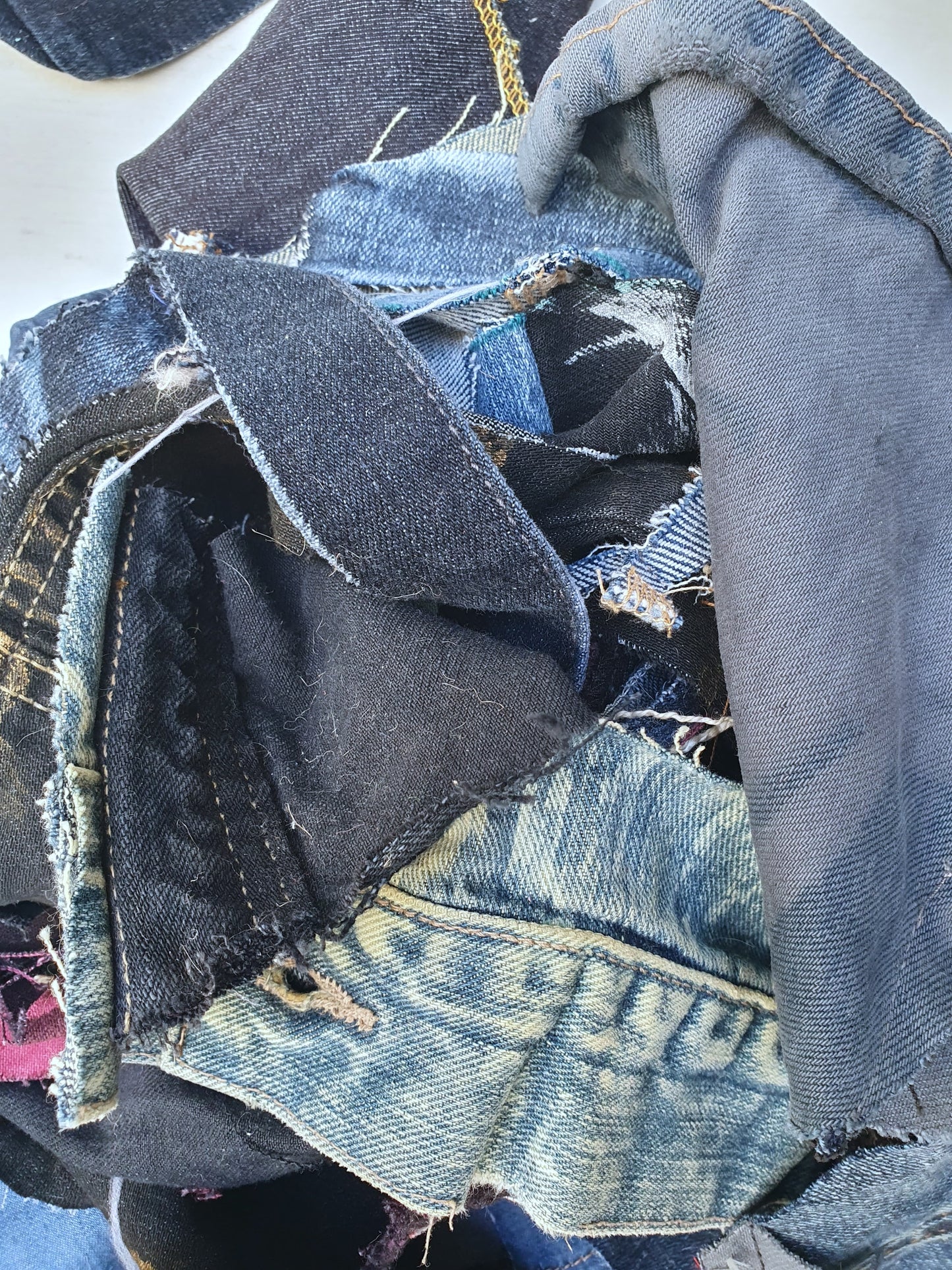 Stack of denim offcuts with various sizes
