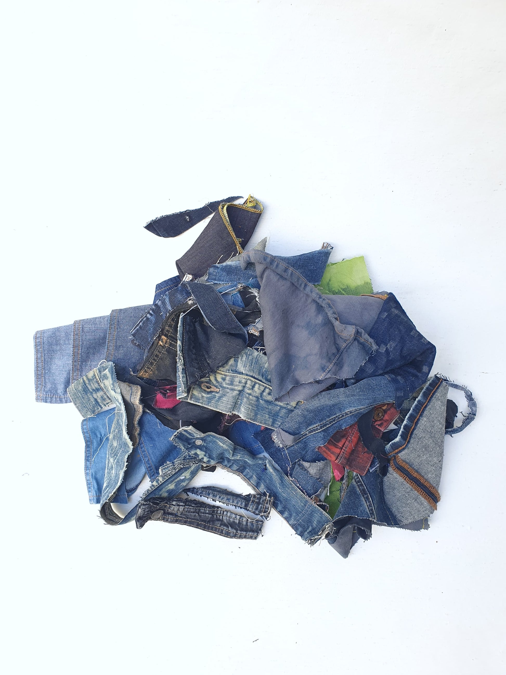 Stack of denim offcuts with various sizes