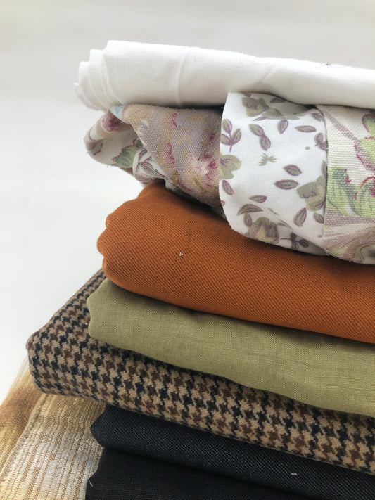Stack of large pieces of earthy-coloured fabrics 