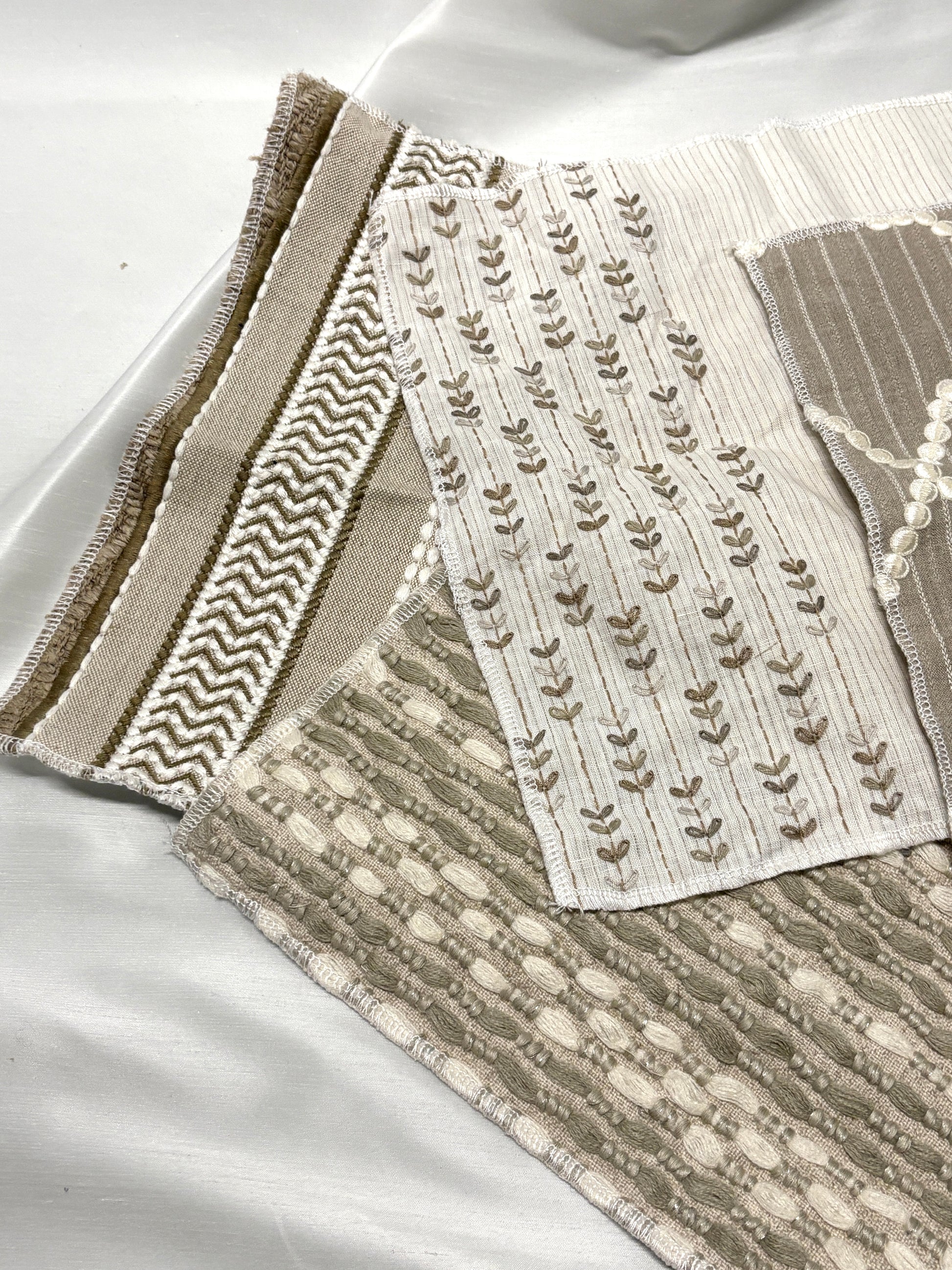 Stack of embroidered fabric with various patterns and colours 