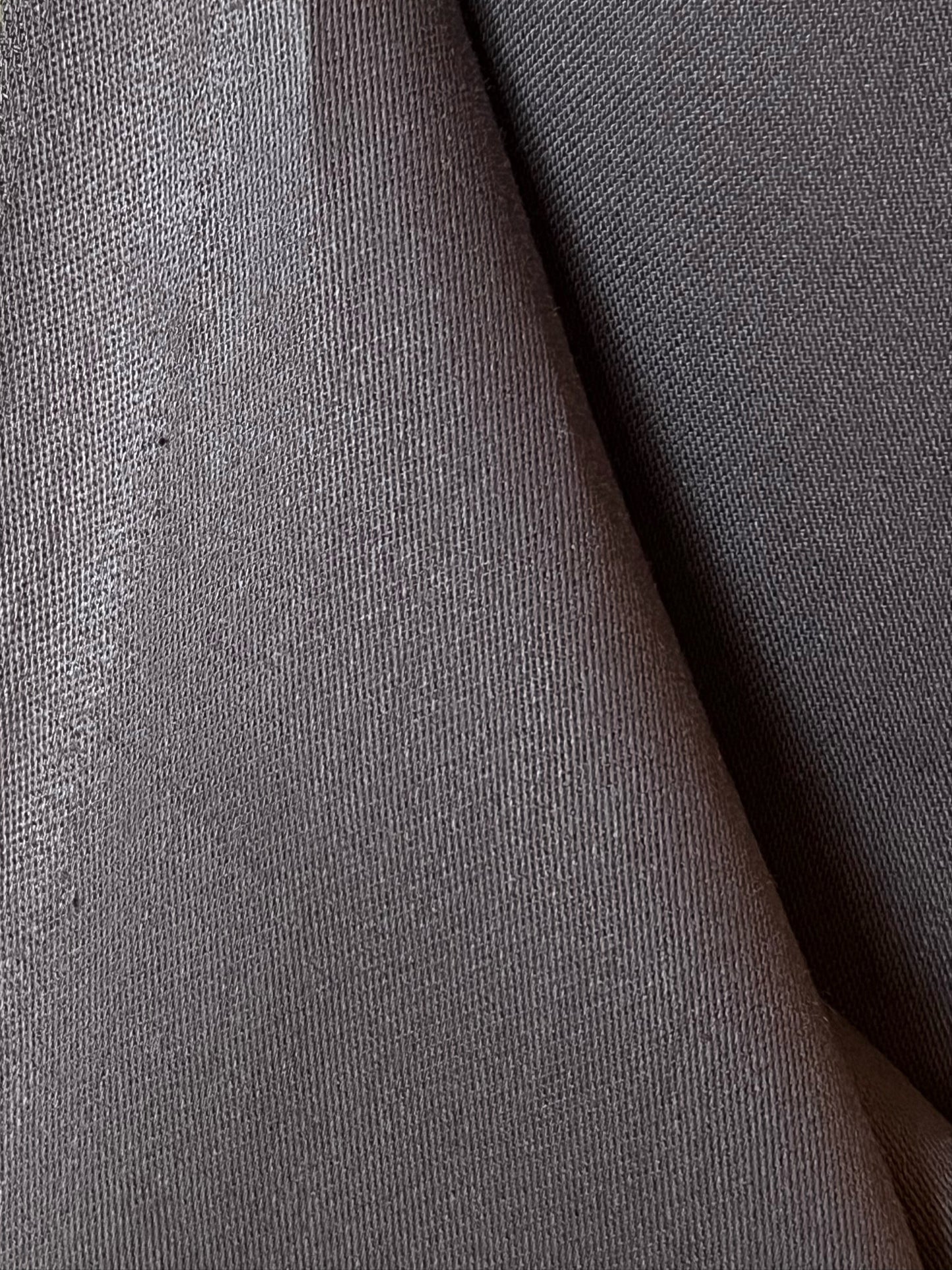 Close-up of organic cotton satin fabric in chocolate brown