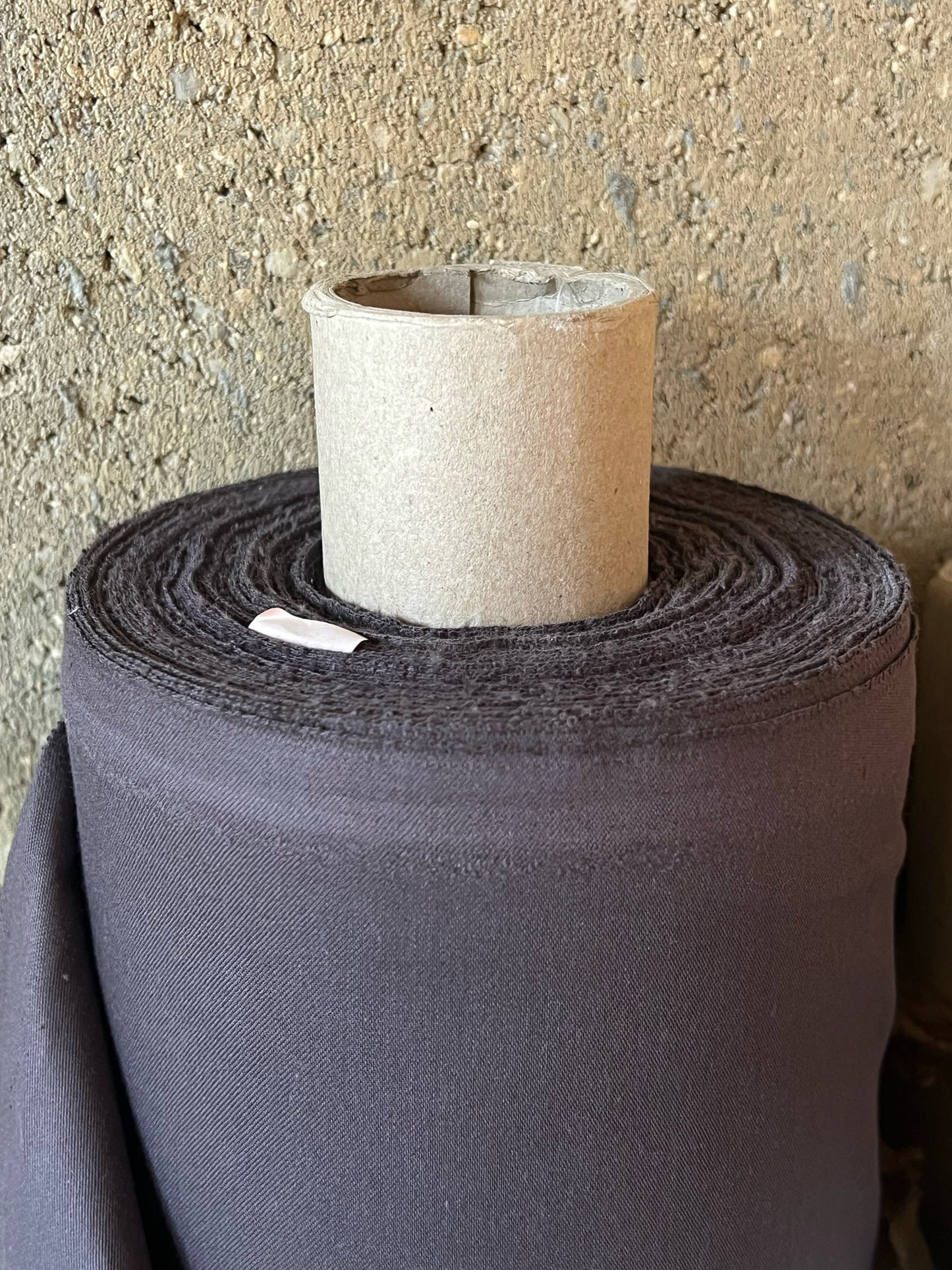 Roll of organic cotton satin fabric in chocolate brown