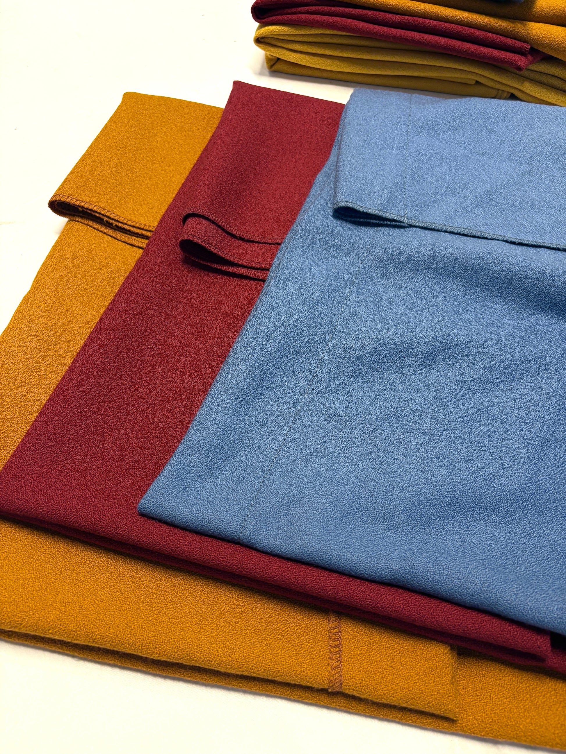Wool crepe fabric in blue, yellow, and red 