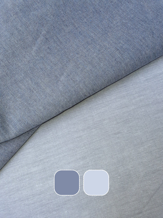 Close-up of chambray cotton fabric in blue-grey with colour swatches below