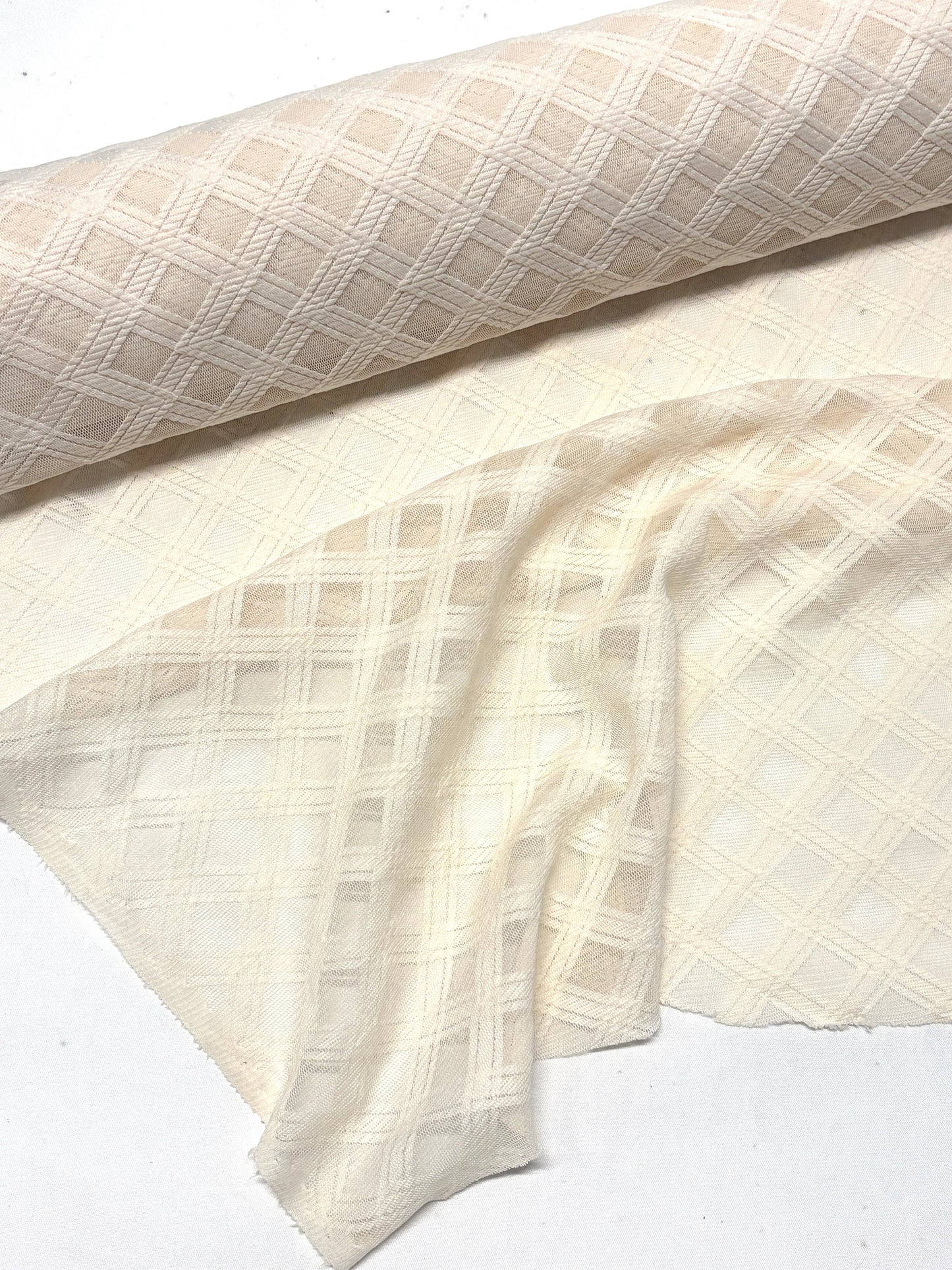 Close-up of crossover mesh fabric in cream, soft texture visible 