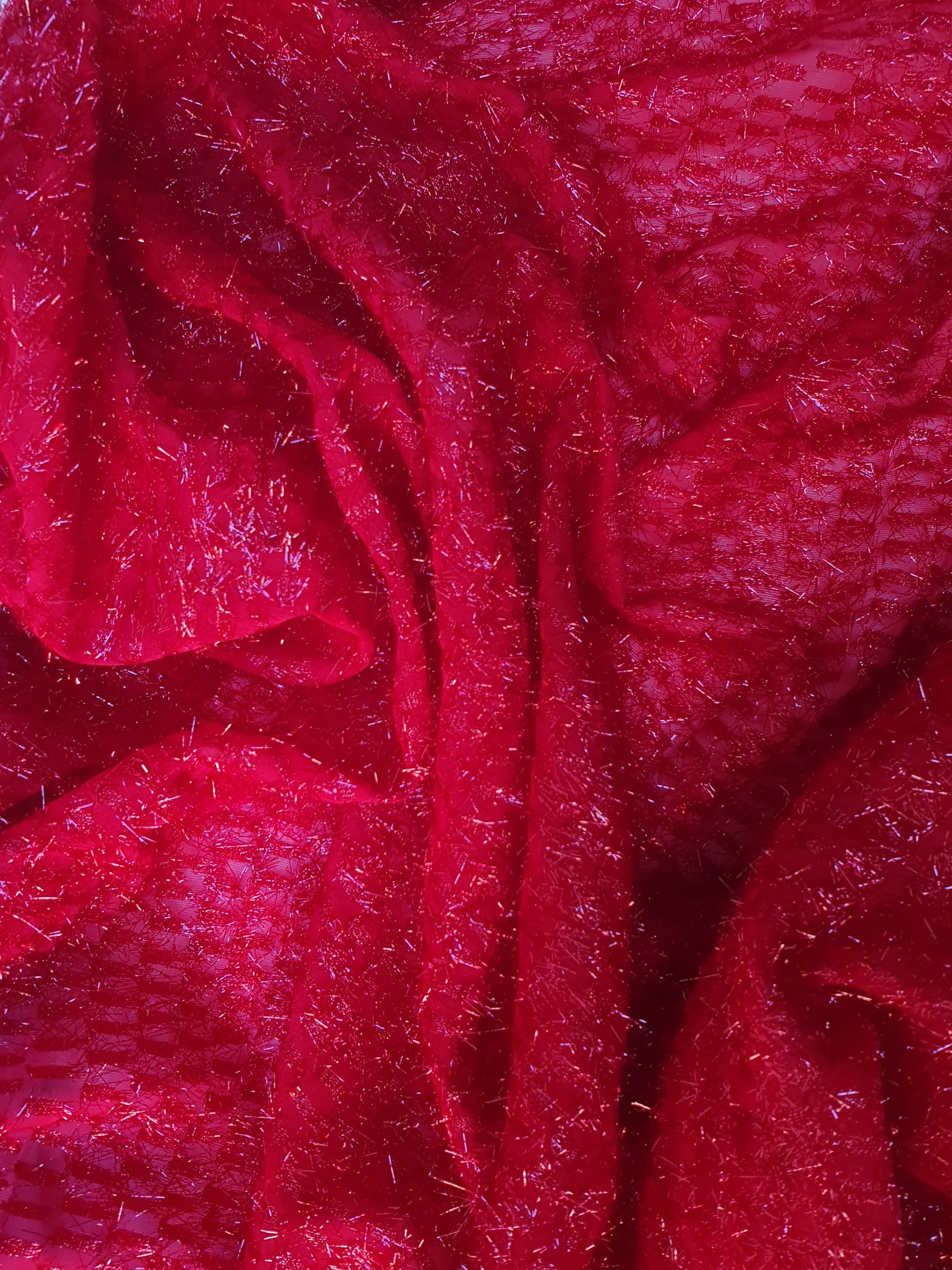Close-up of sparkly embroidered fabric in red