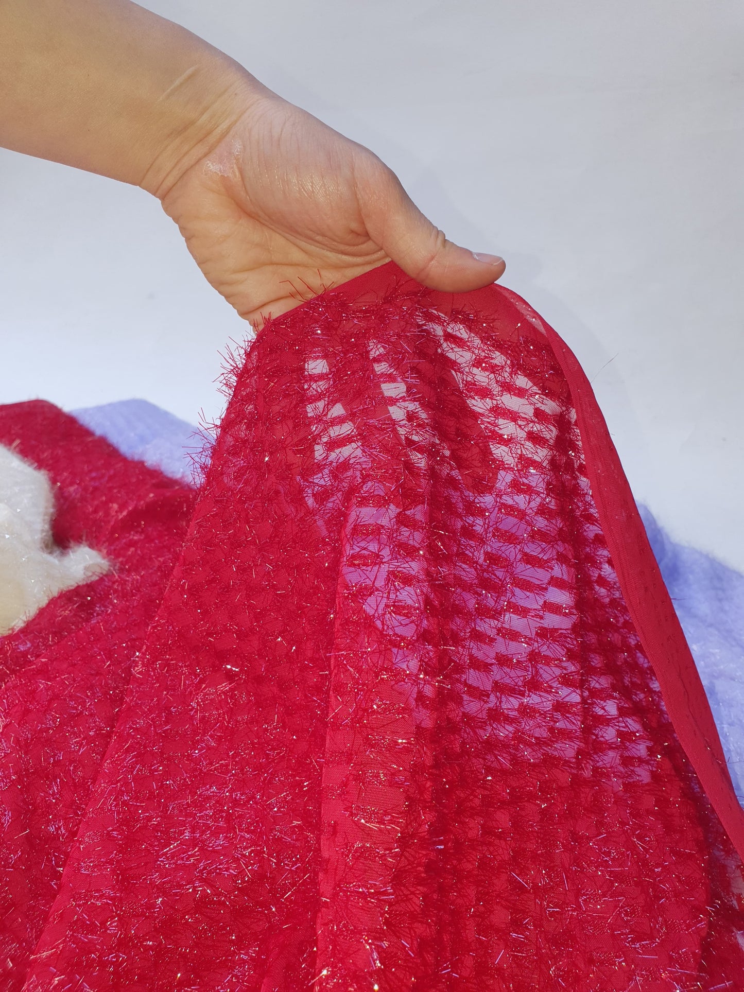Close-up of sparkly embroidered fabric in red