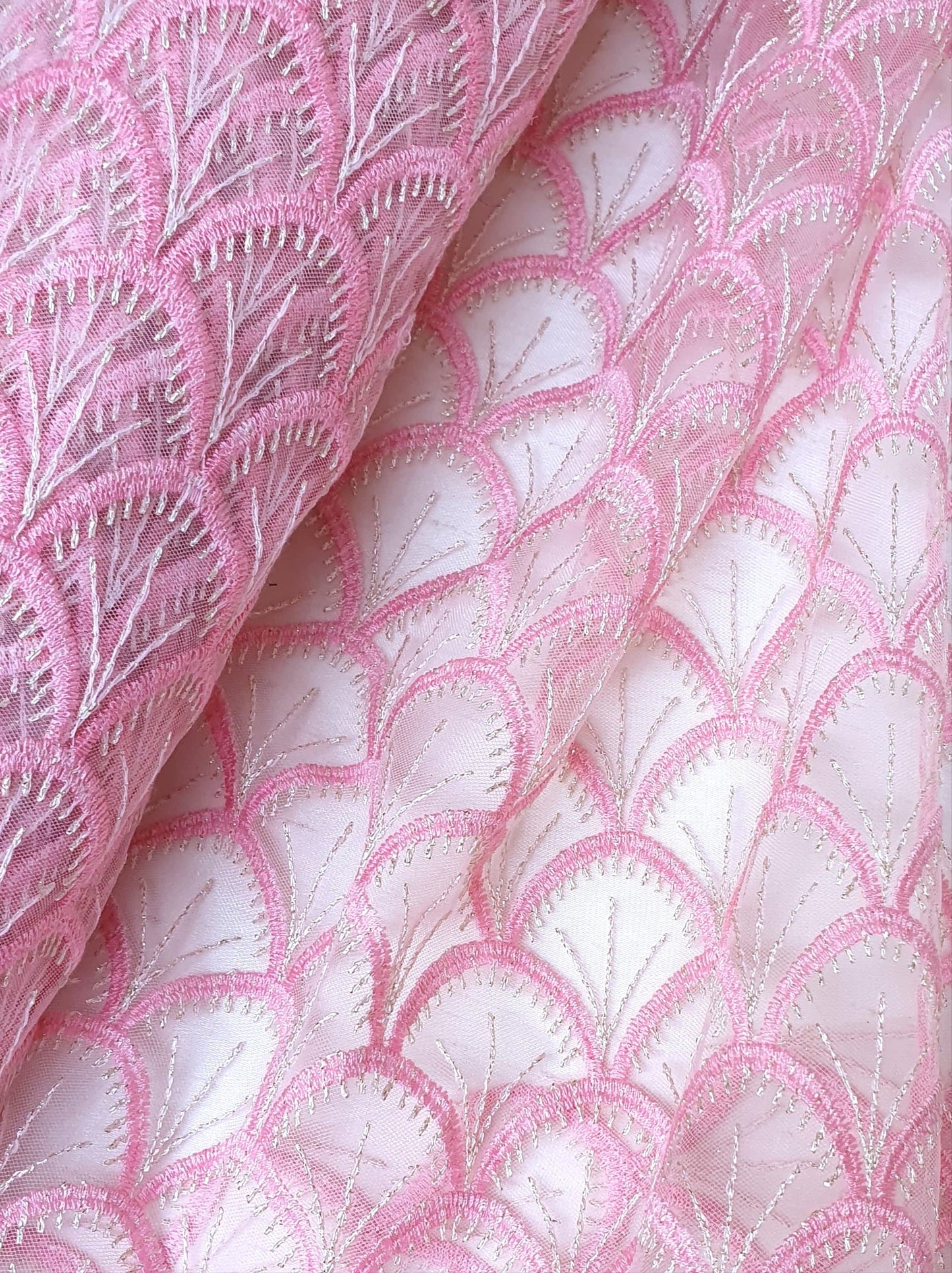 Close-up of embroidery lace fabric in pink 