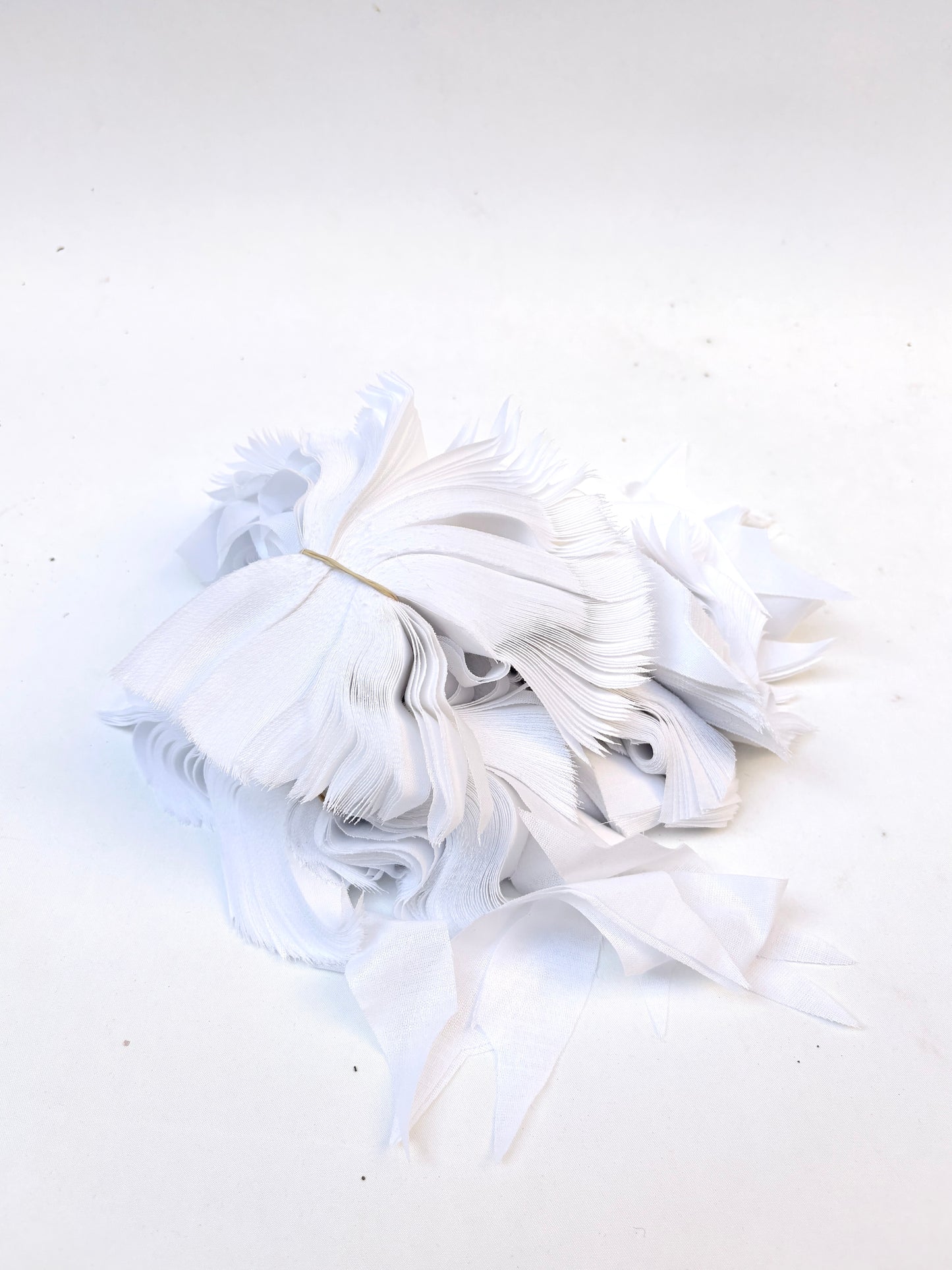 Bundles of fusible woven interfacing offcuts fabric in white 